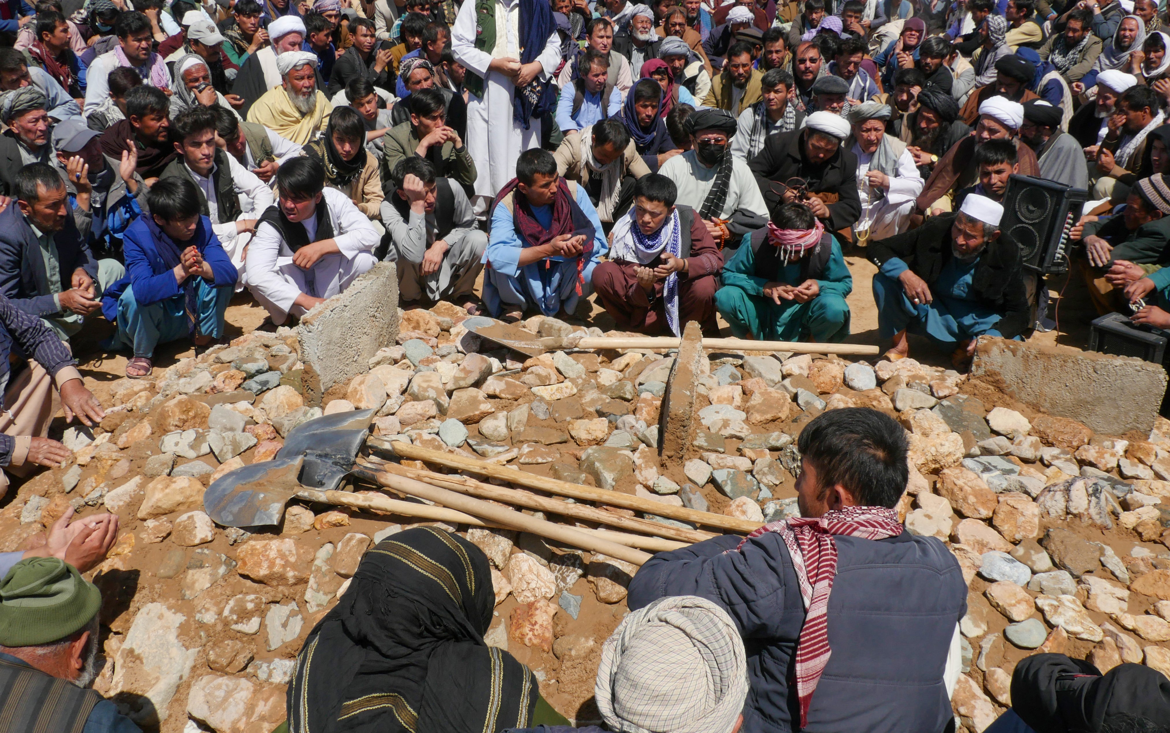 Afghans mourn at a burial ceremony of the slain Shiite Muslims after gunmen attacked a mosque in Guzara district of Herat province