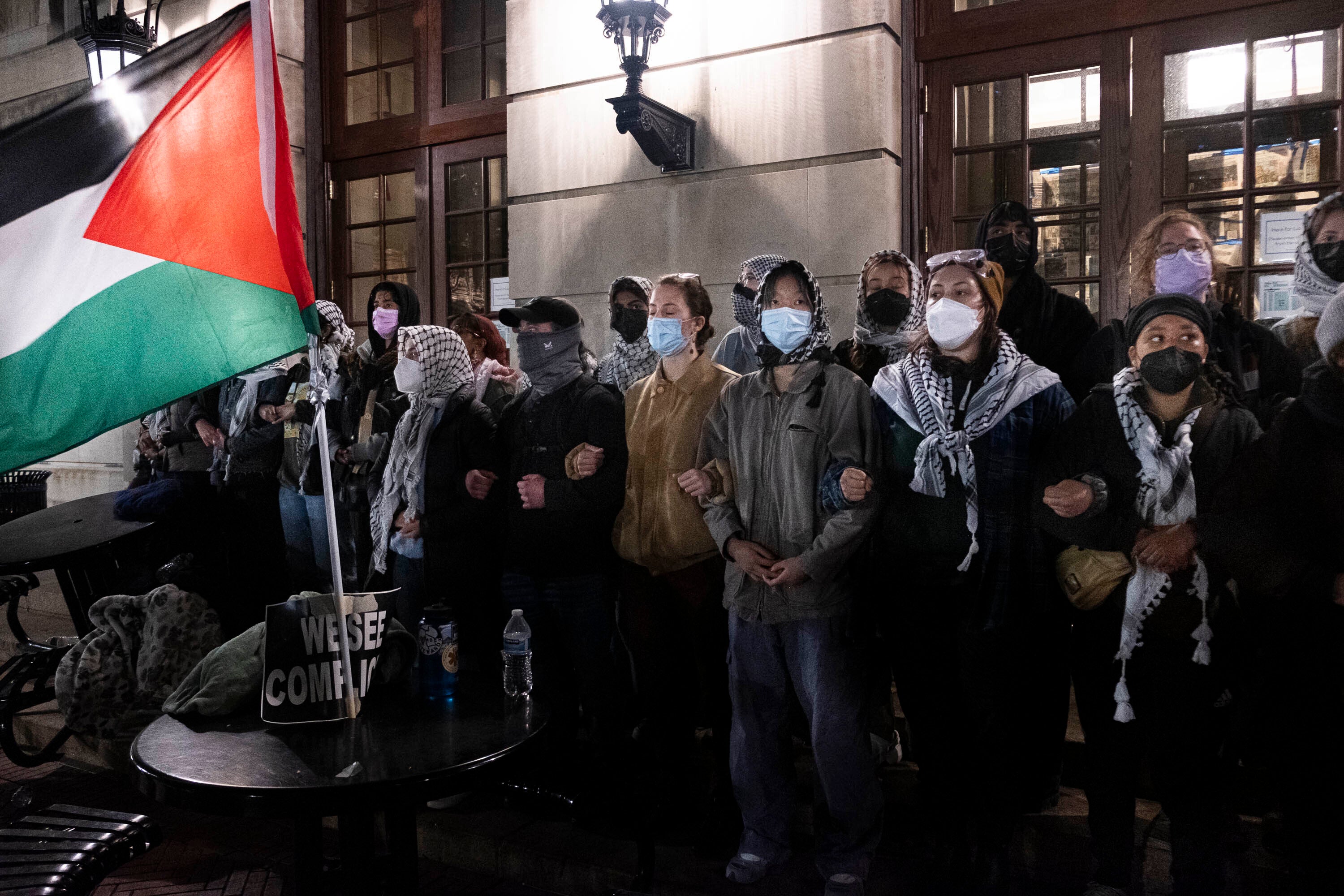 Pro-Palestinian students lock arms, sing and chant as they braced for New York Police Department officers to raid campus on 30 April.