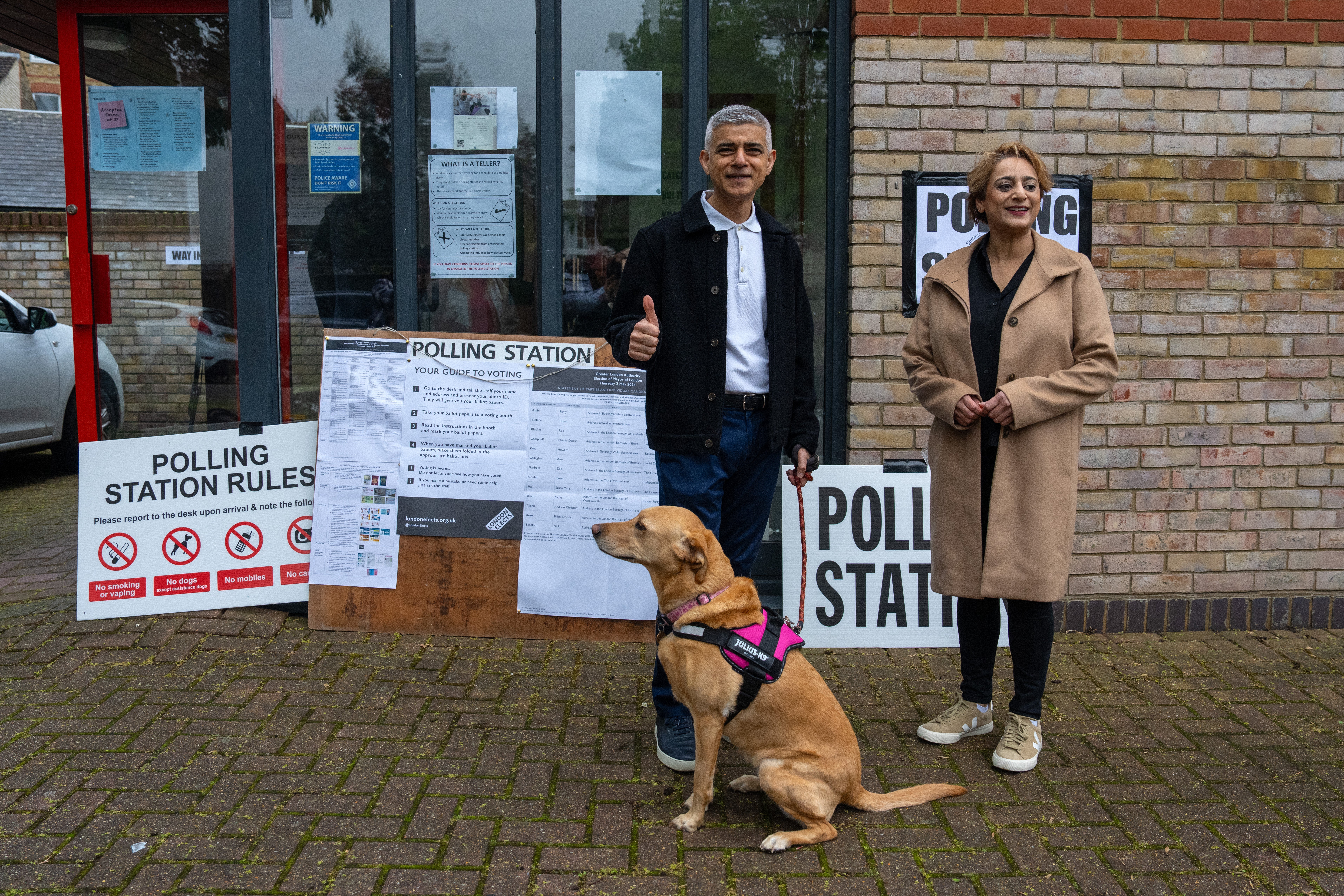 London Mayor Sadiq Khan and his wife Saadiya arrive with their dog Luna to cast their vote in the London mayoral election on Thursday