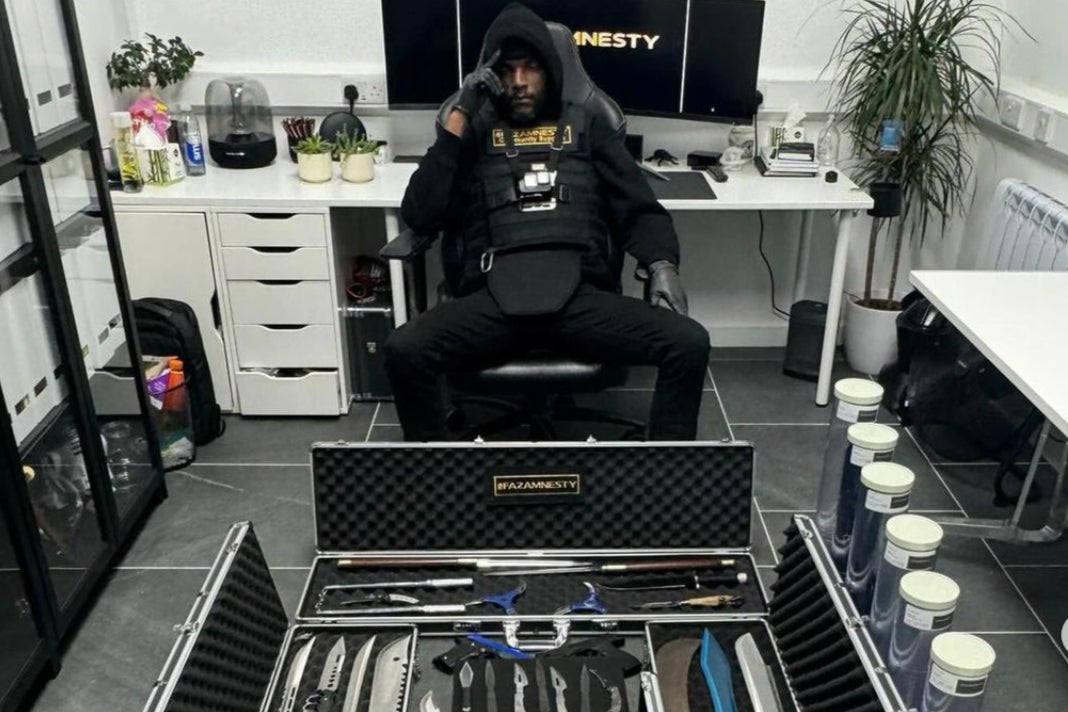 Faron Paul in his office, wearing the stab-proof vest he wears for knife pick ups