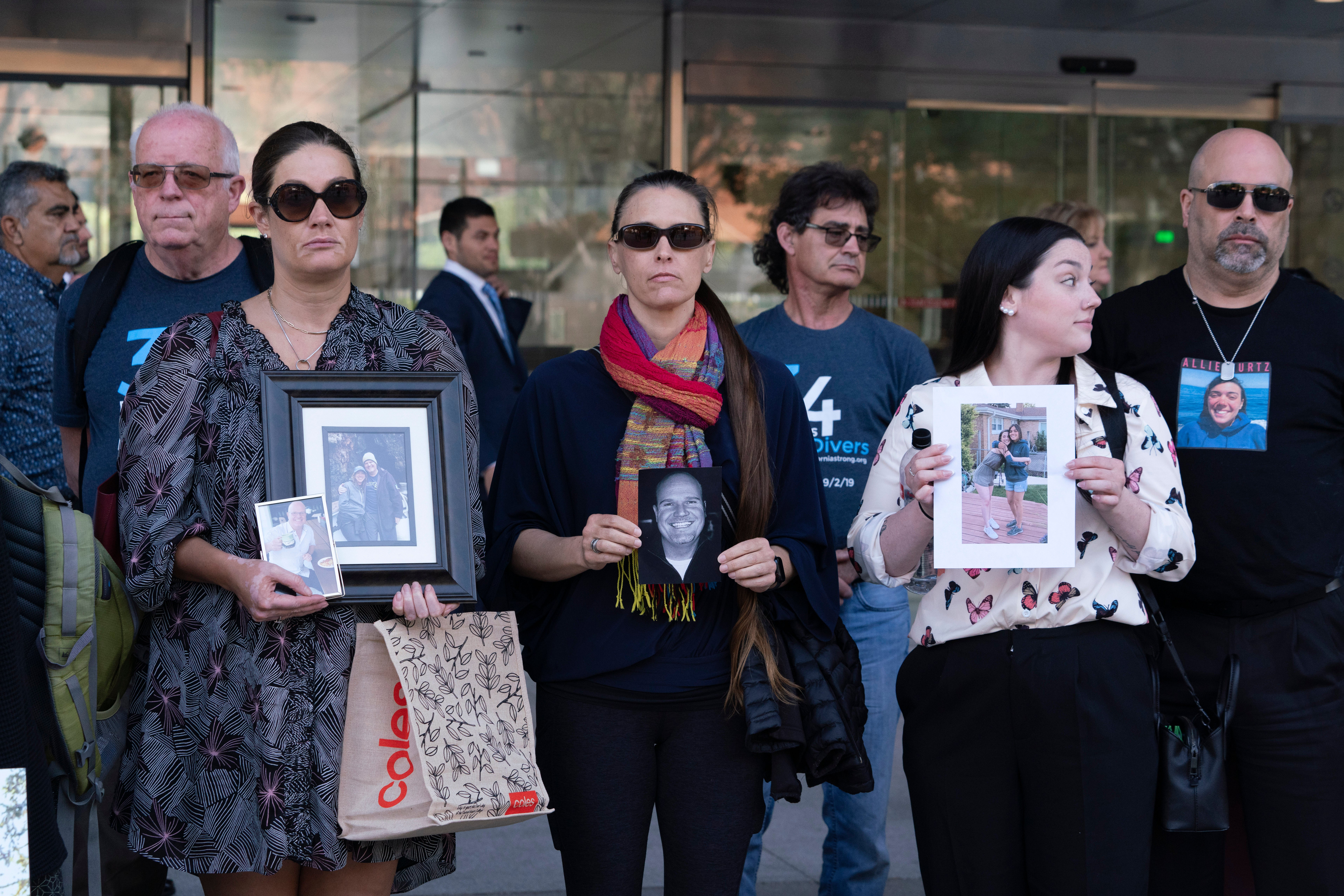 Family members of the 34 people who died during the Conception dive boat fire in 2019 hold photos of their loved ones outside the US Federal Building in downtown Los Angeles