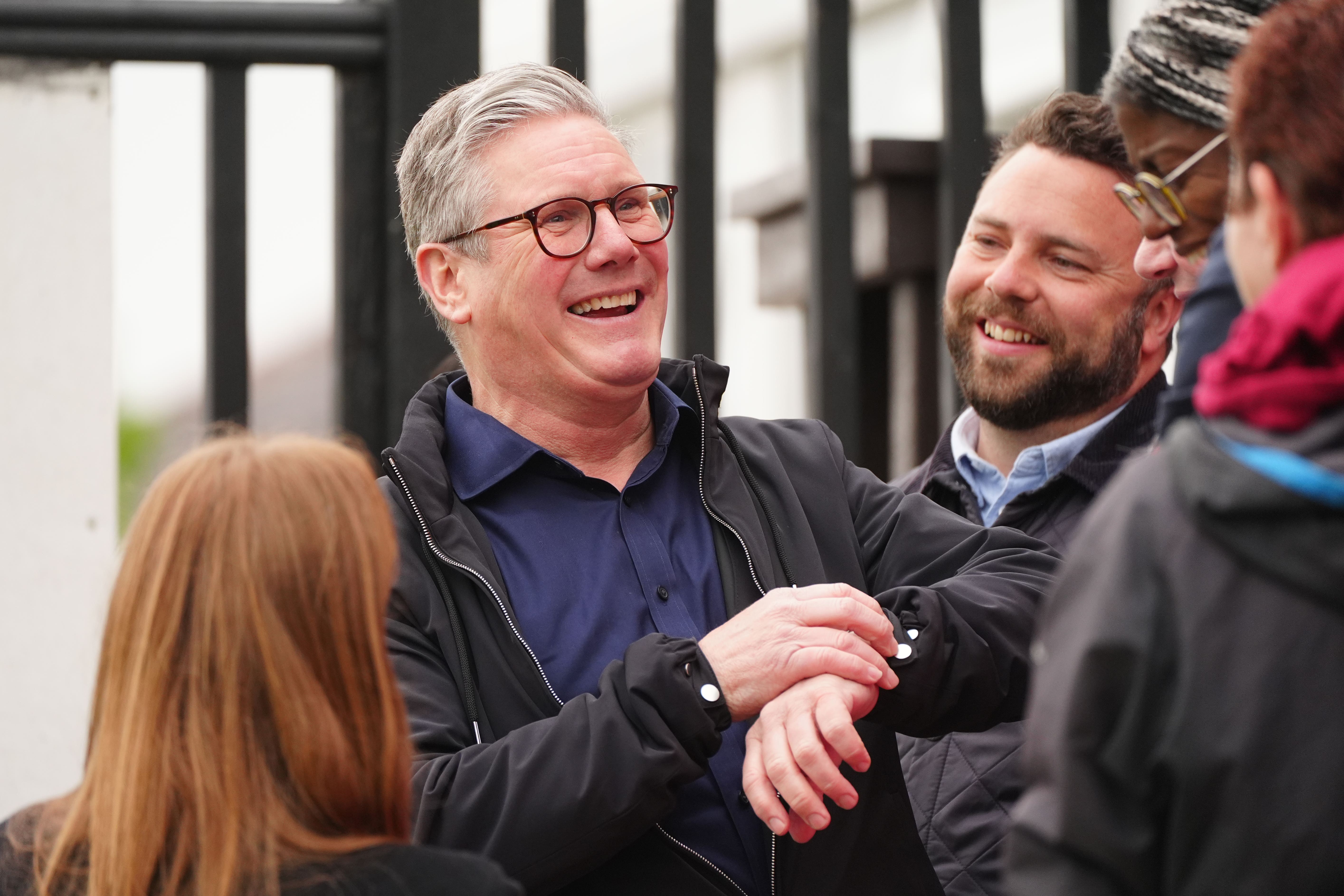 Labour leader Sir Keir Starmer looks at his watch as he celebrates at Blackpool Cricket Club after Chris Webb was declared winner in the Blackpool South by-election (Peter Byrne/PA)