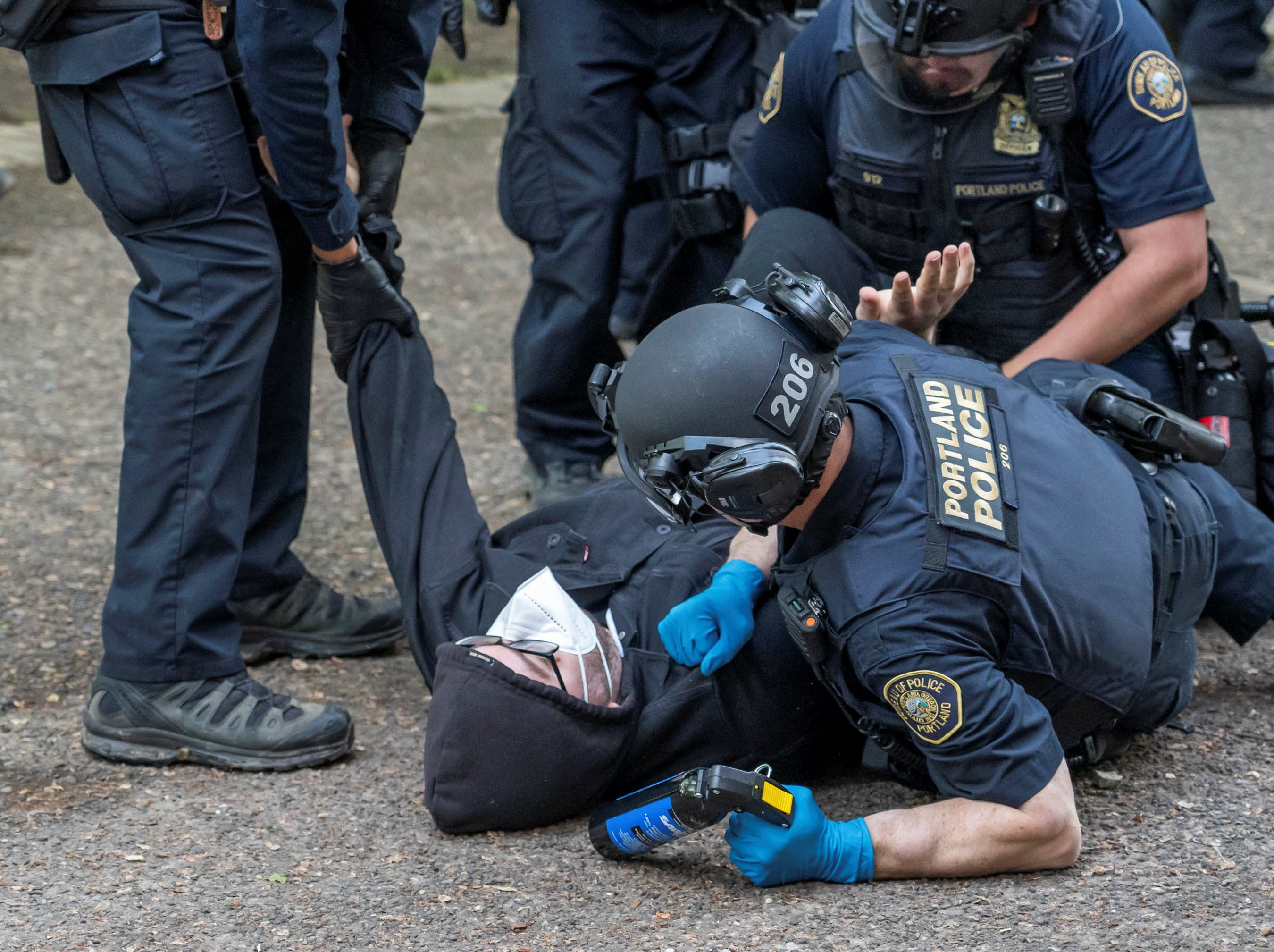 Portland Police detain a protester who re-occupied the Portland State University Library building with others after it had been cleared and several protesters were detained earlier in the day, during the ongoing conflict between Israel and the Palestinian Islamist group Hamas, in Portland, Oregon, U.S., May 2, 2024