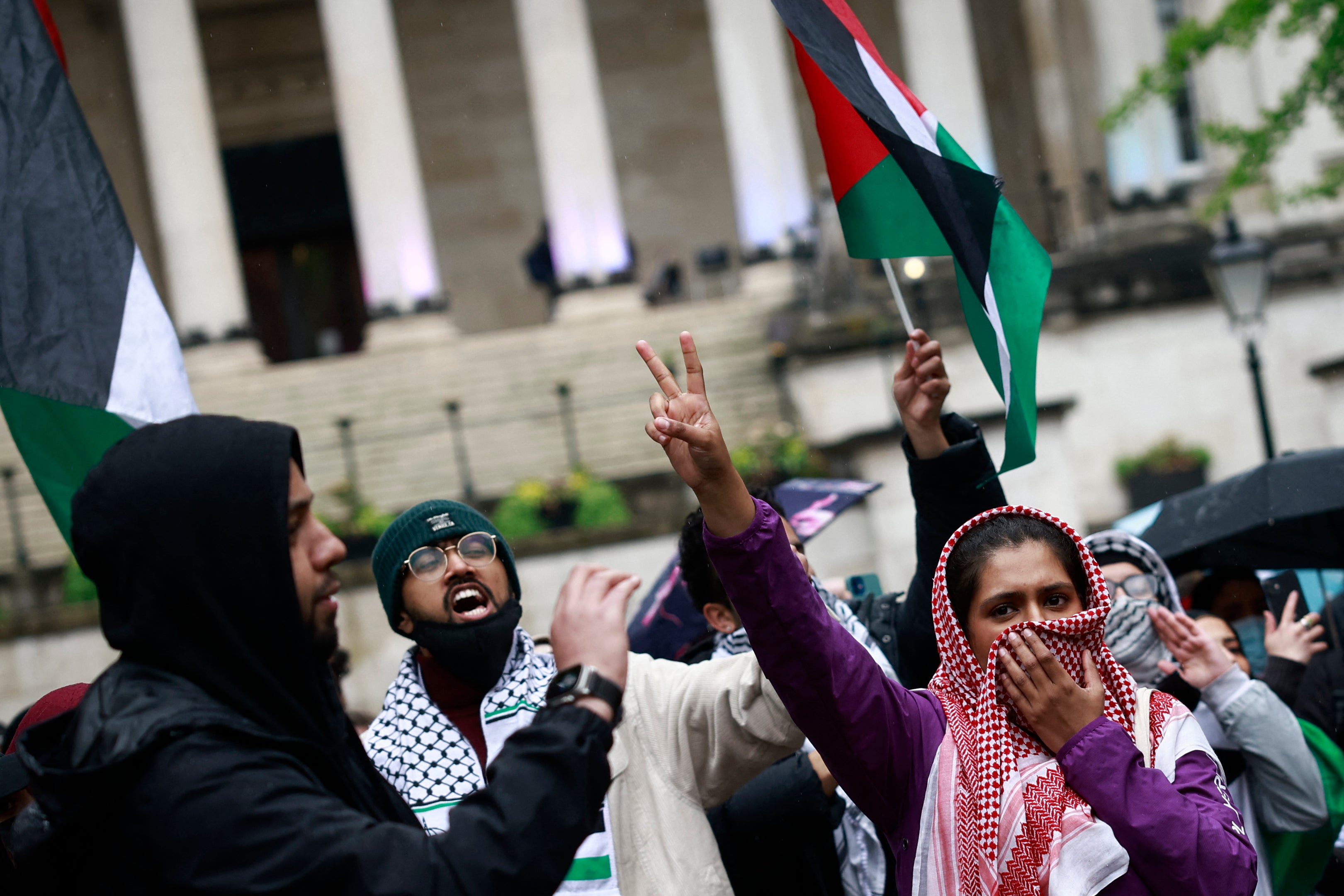 Students waving the Palestinian flag take part in a demonstration in support of Palestinian people at University College London