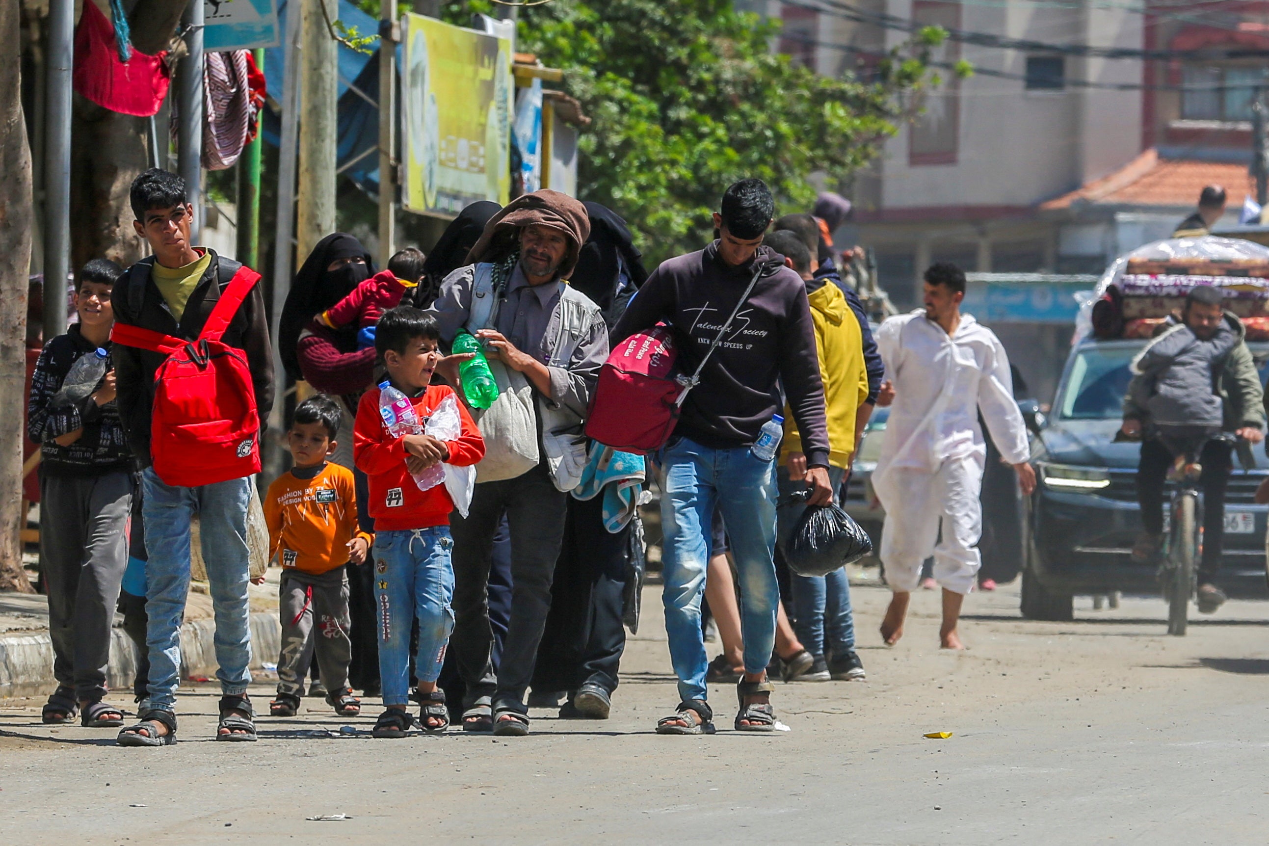 Palestinians leave Rafah with water, rucksacks and bin bags after the ‘unlawful’ evacuation order by Israeli authorities