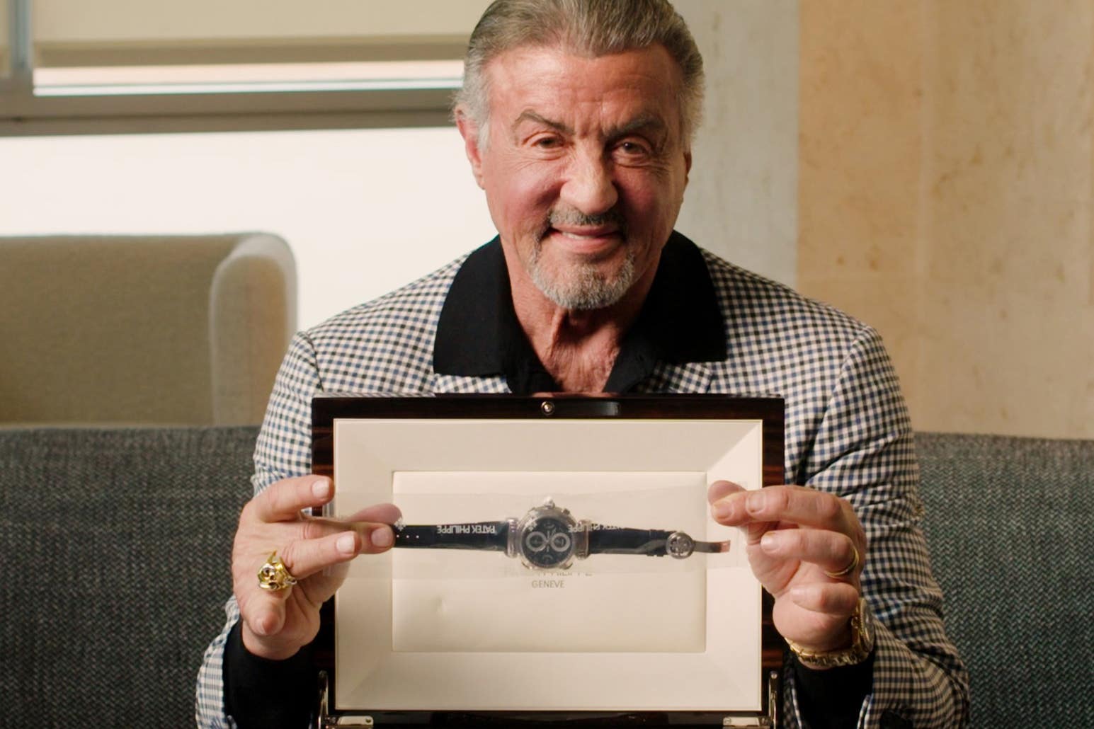 Sylvester Stallone with one of his watches being auctioned (Sotheby’s/PA)