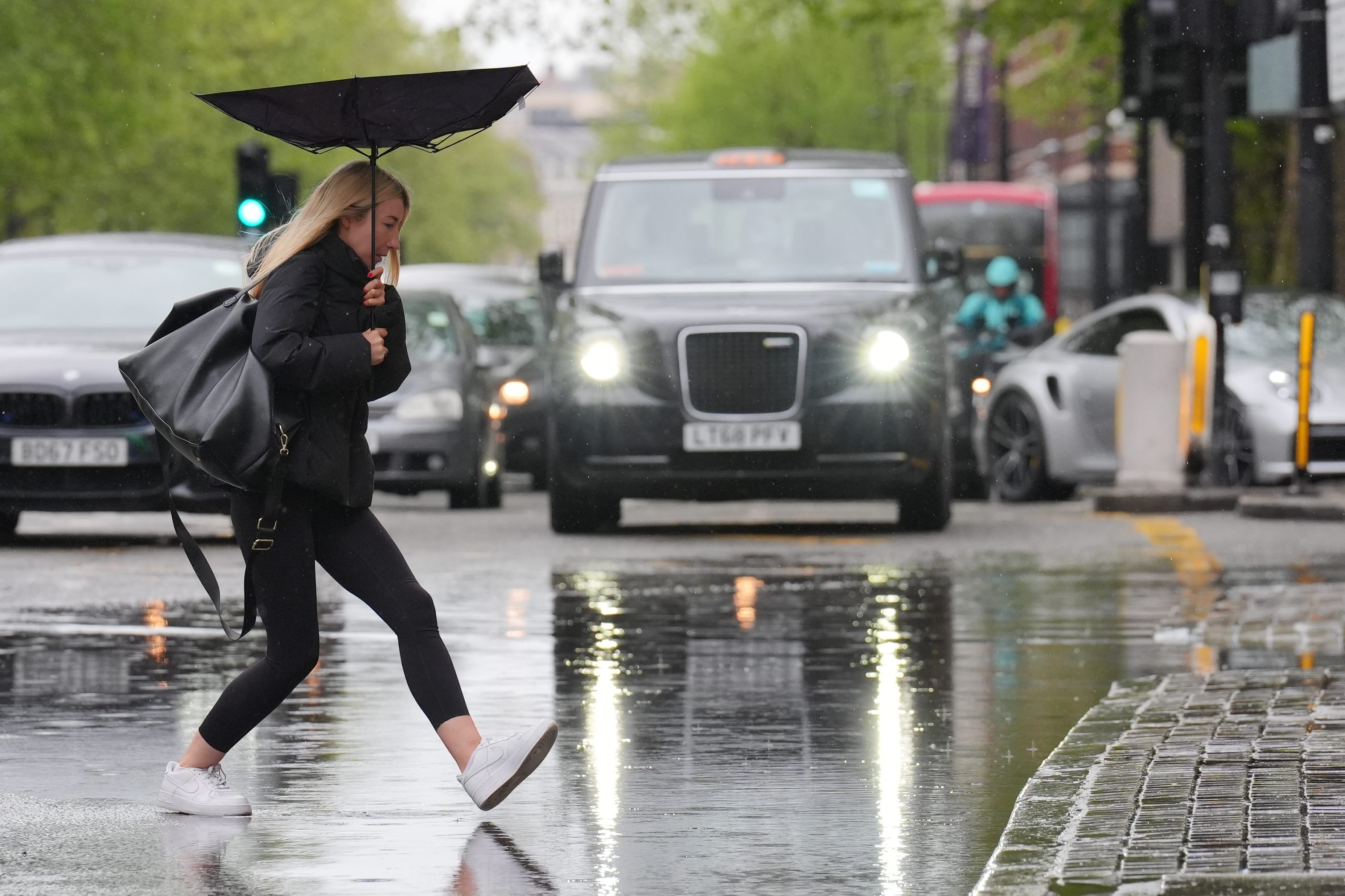 Poor weather held consumer spending back last month, as fewer people hit the high street (Jonathan Brady/PA Wire)