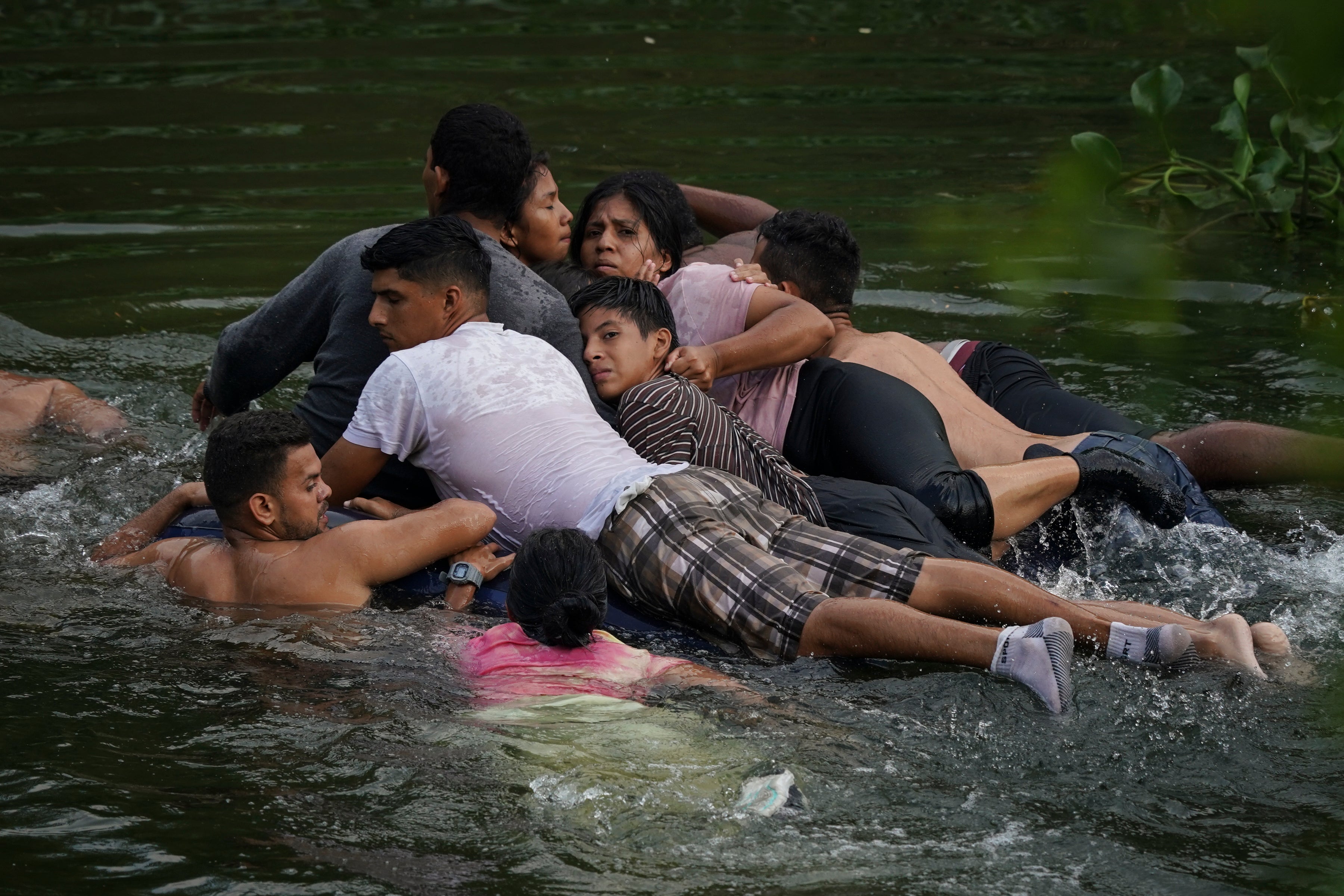 Migrants cross the Rio Bravo on an inflatable mattress into the United States from Matamoros, Mexico, on May 9, 2023