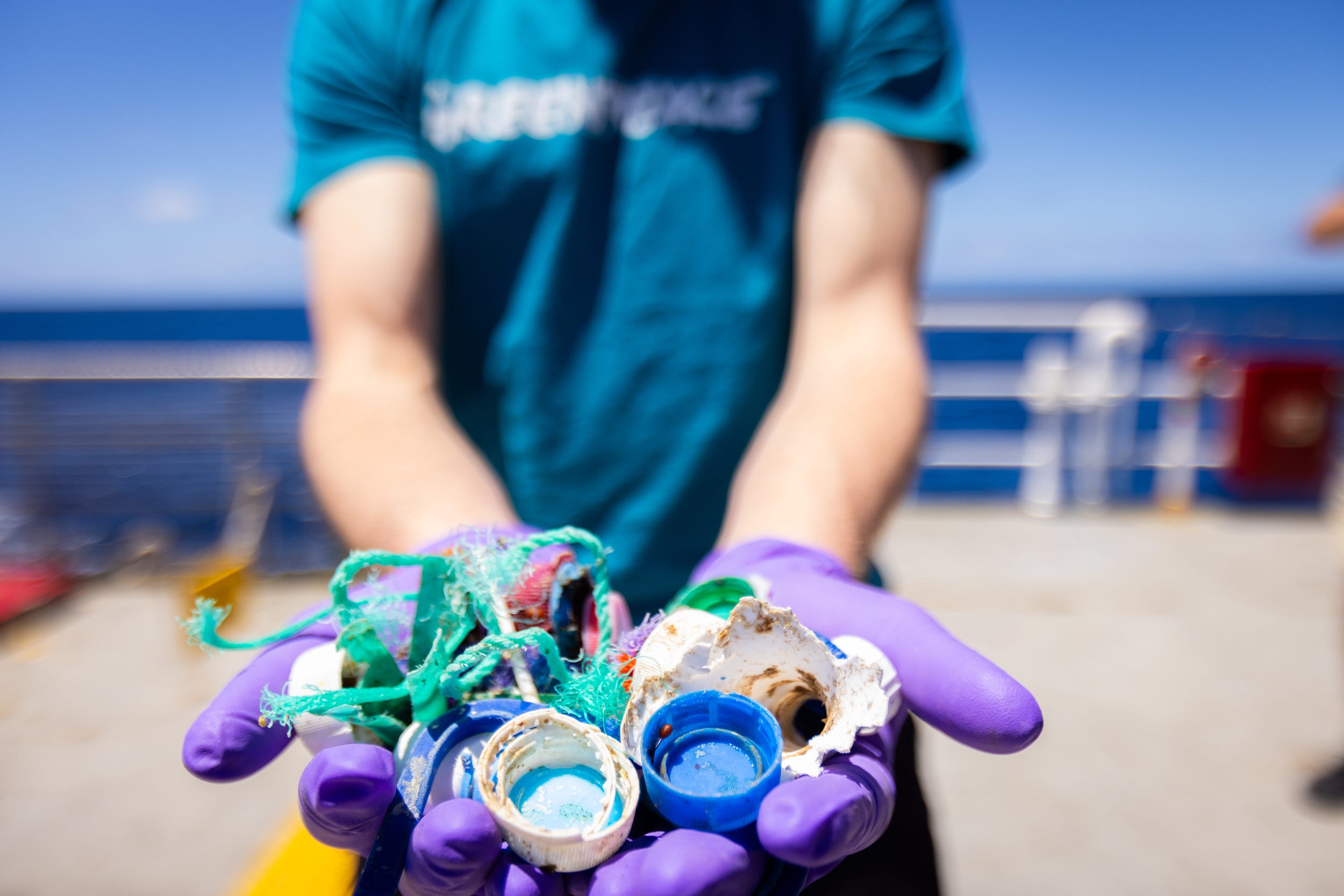 A member of Greenpeace holding up the plastic found in the Sargasso Sea in the Arctic ocean (Greenpeace/PA)