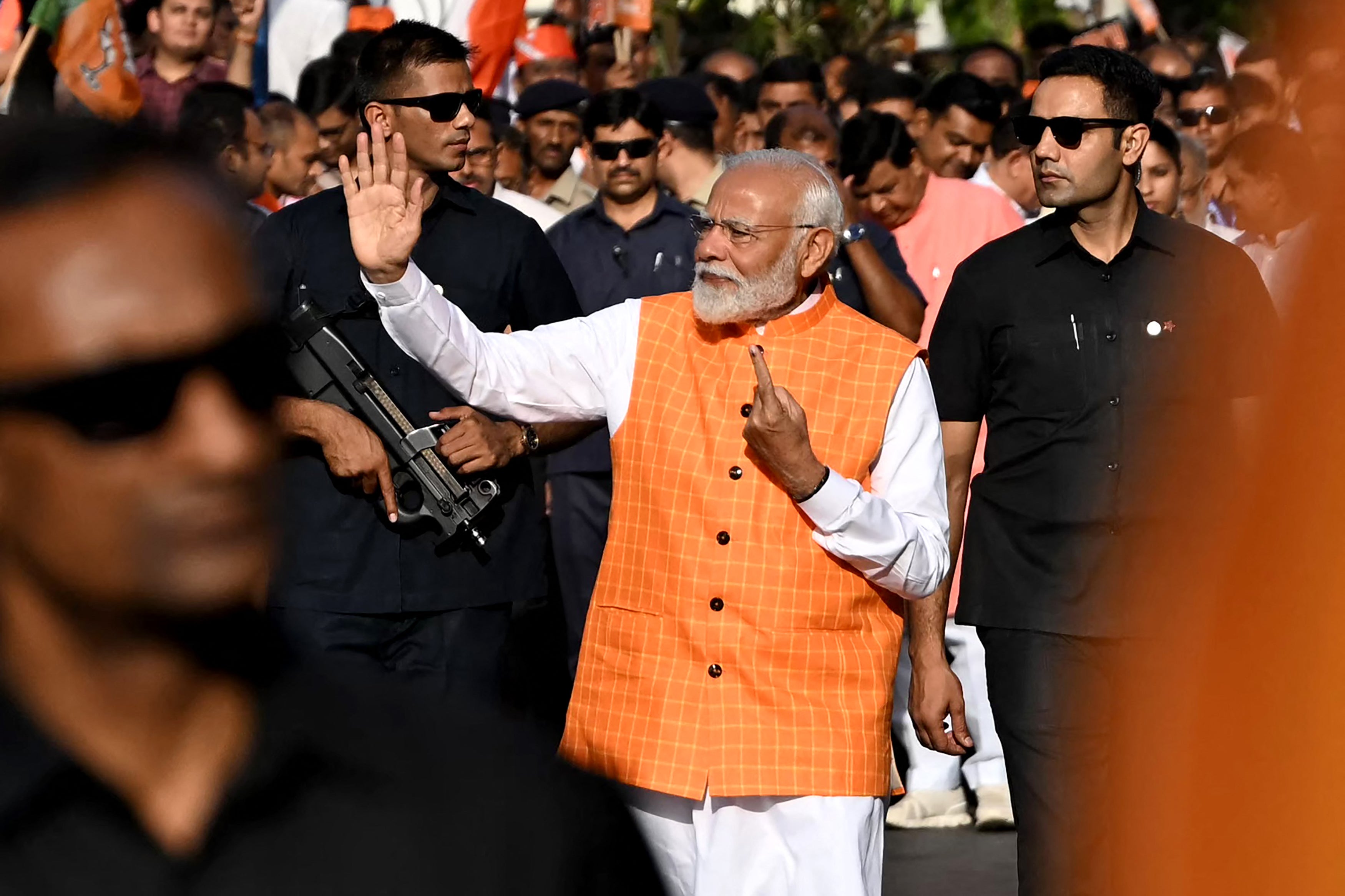 Narendra Modi leaves after casting his vote at a polling booth in Gujarat