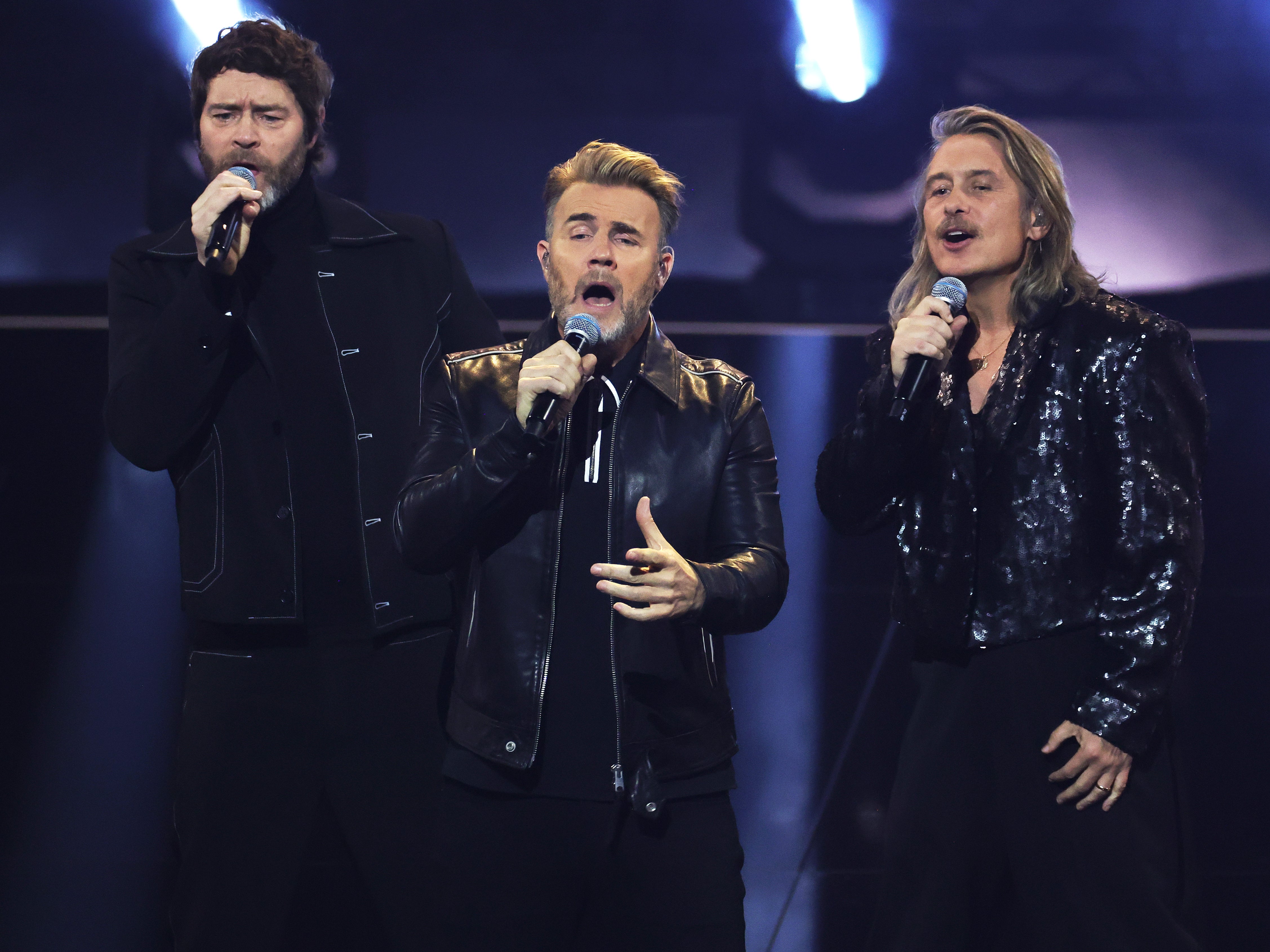 Howard Donald, Gary Barlow and Mark Owen of Take That perform on stage