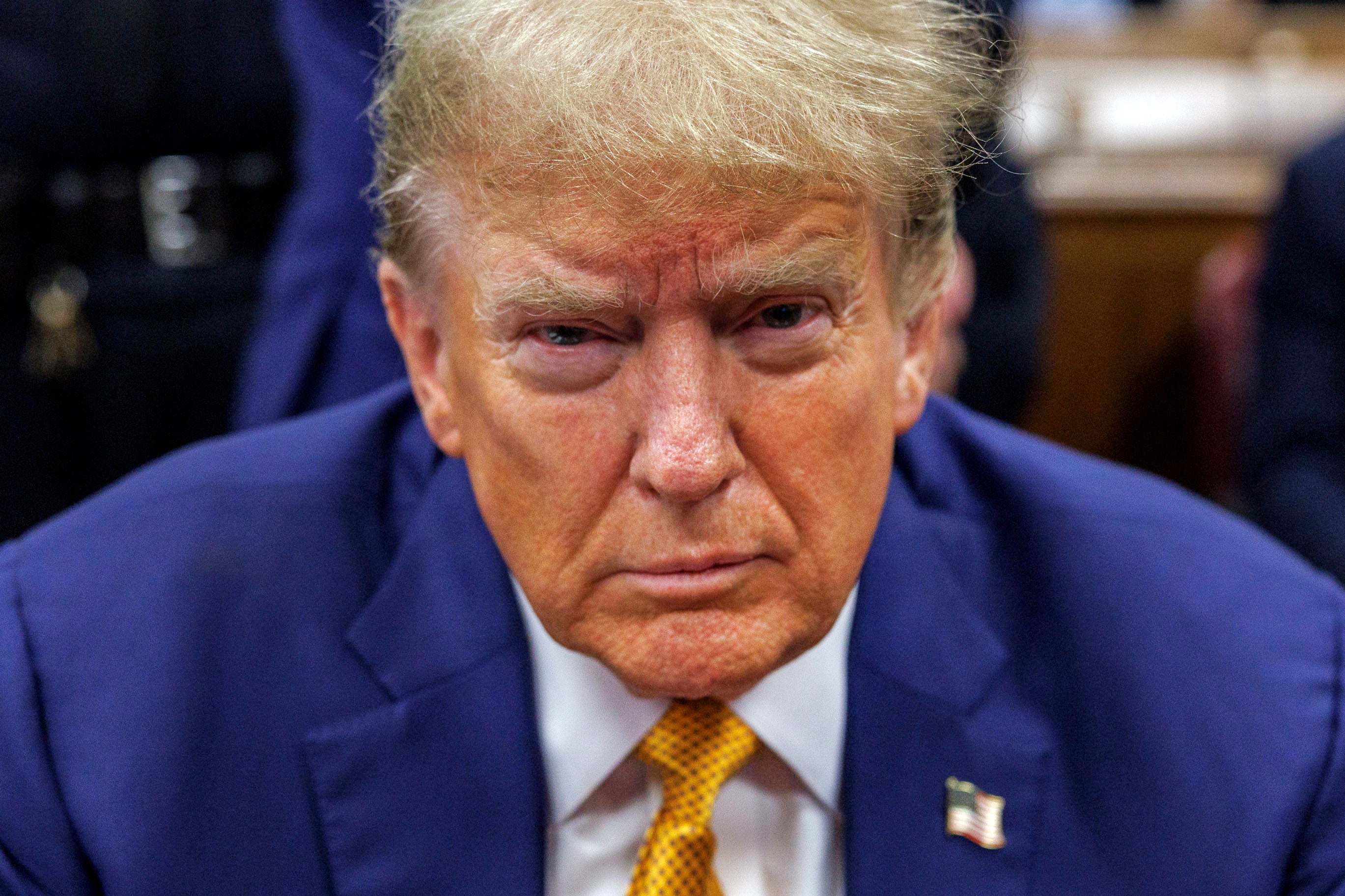 Trump sits at the defense table in Manhattan criminal court on 7 May