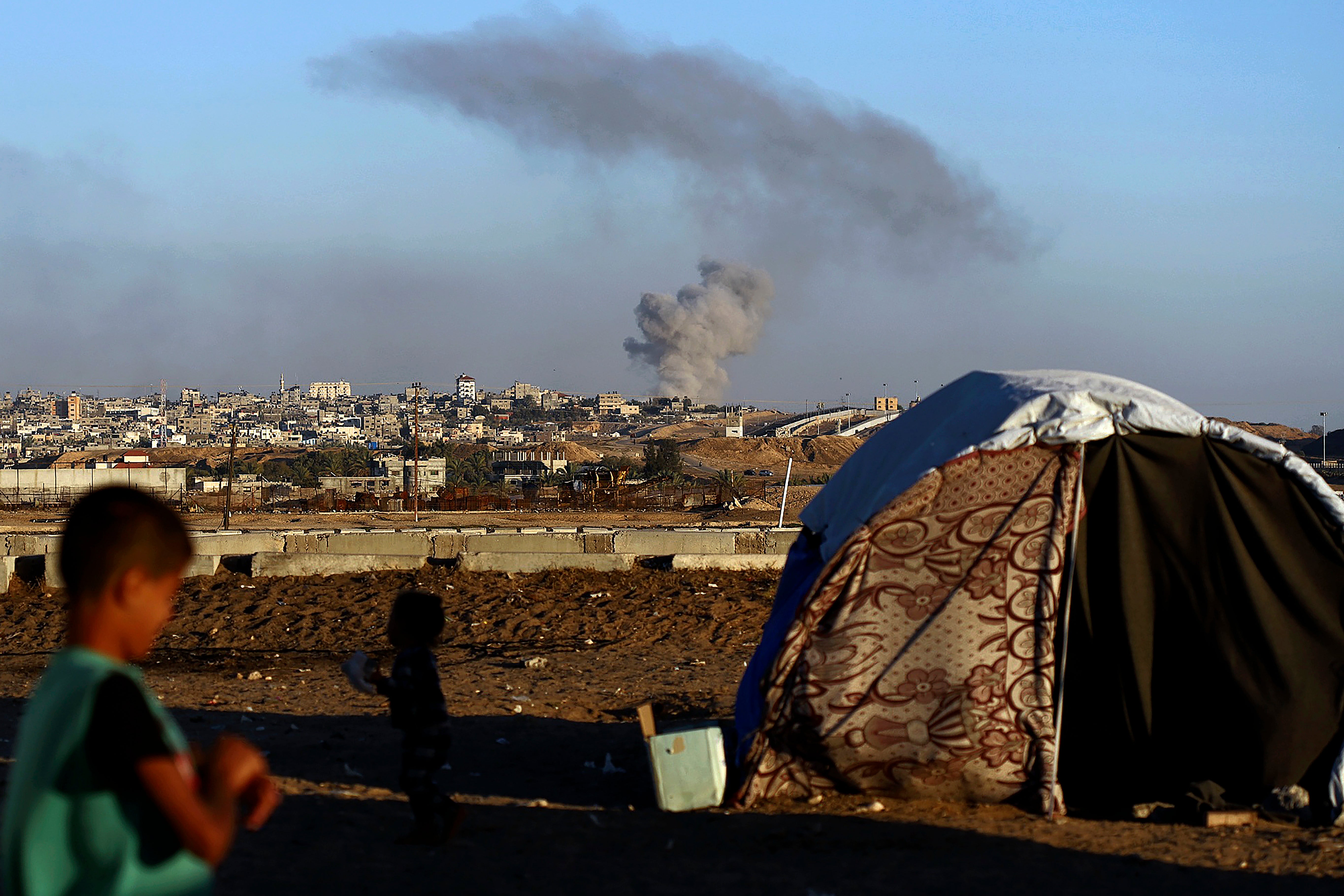 Smoke rises following an Israeli airstrike on buildings near the separating wall between Egypt and Rafah