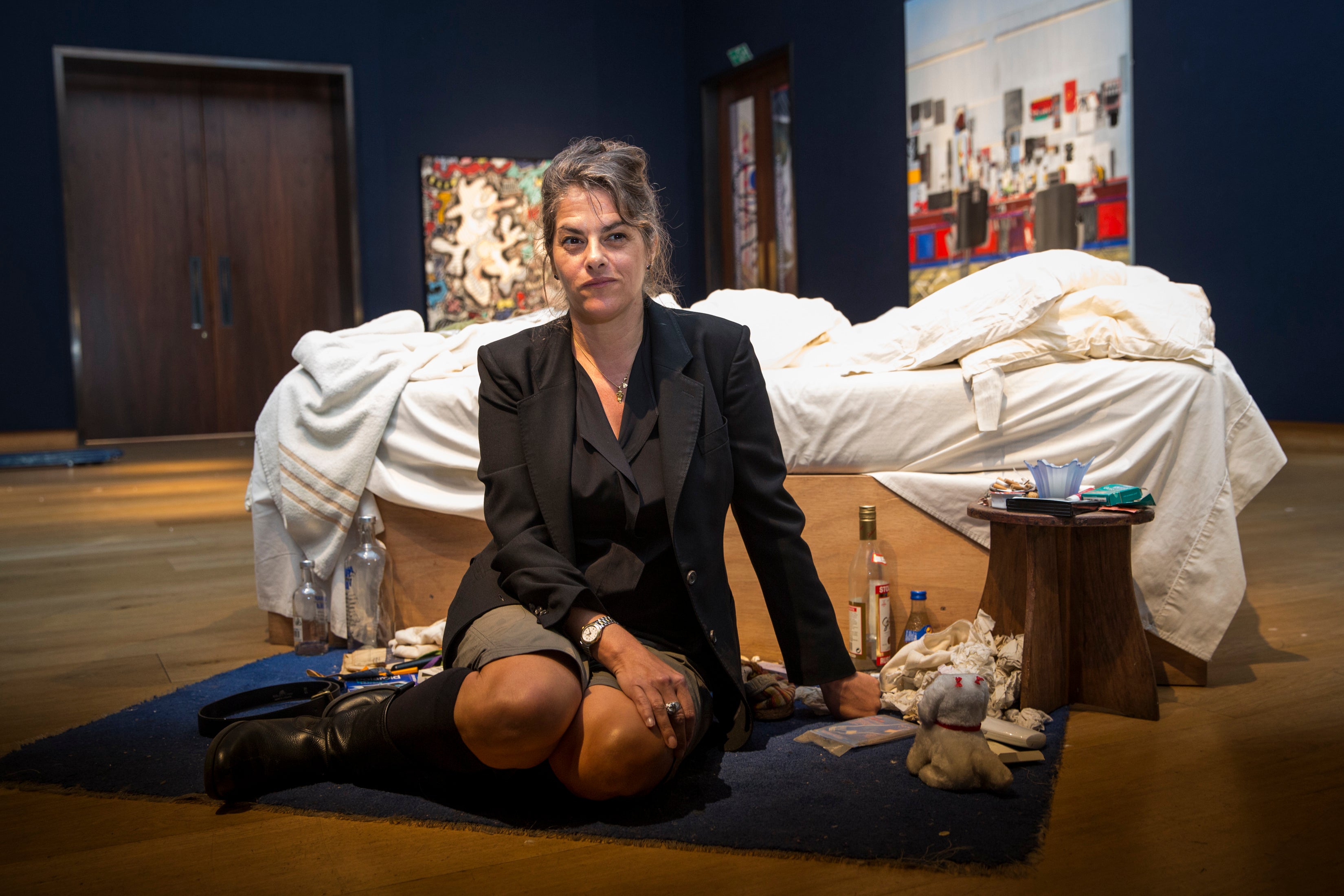 Emin sits in front of her 1998 piece ‘My Bed’ on display at Christie’s in 2014