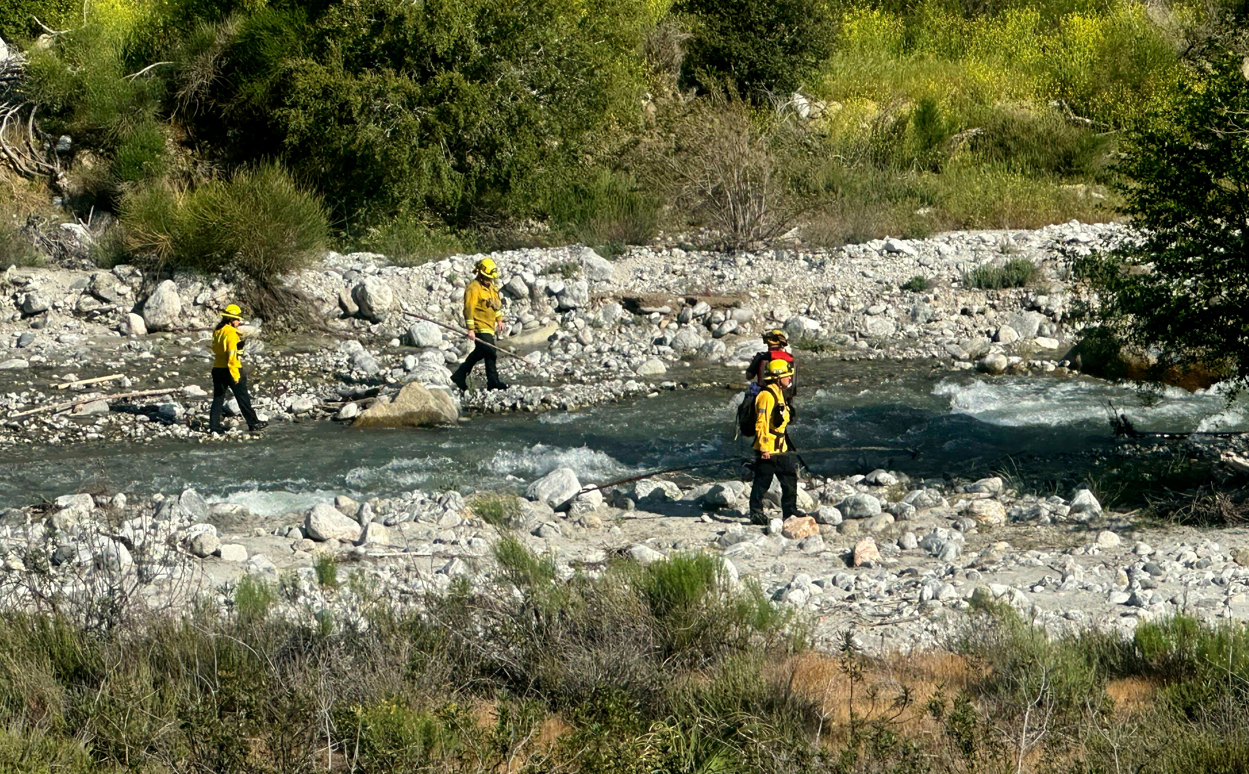 San Bernardino County Fire Department officials search for the two children