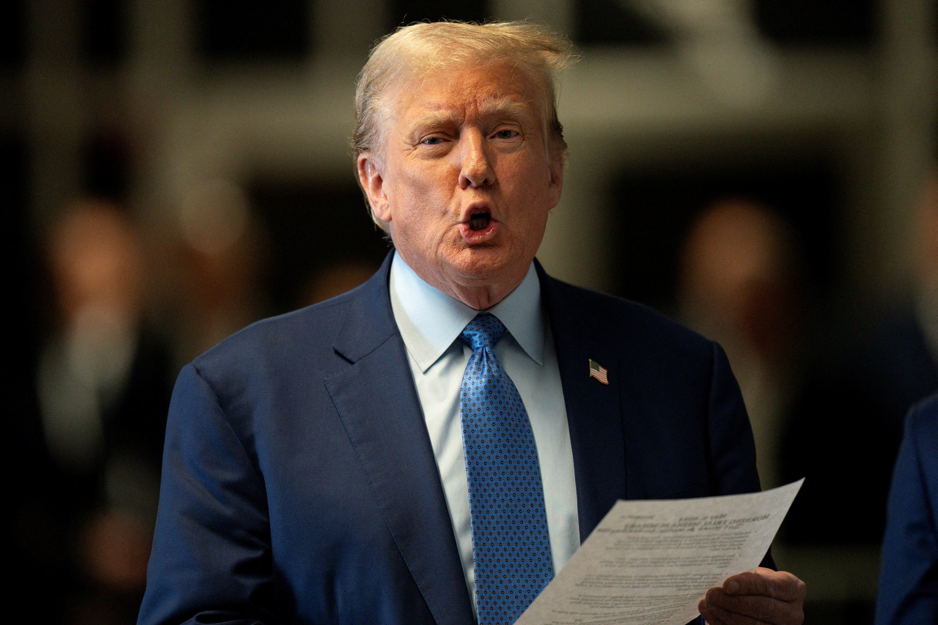 Donald Trump addresses reporters before walking into court on Thursday, 9 May