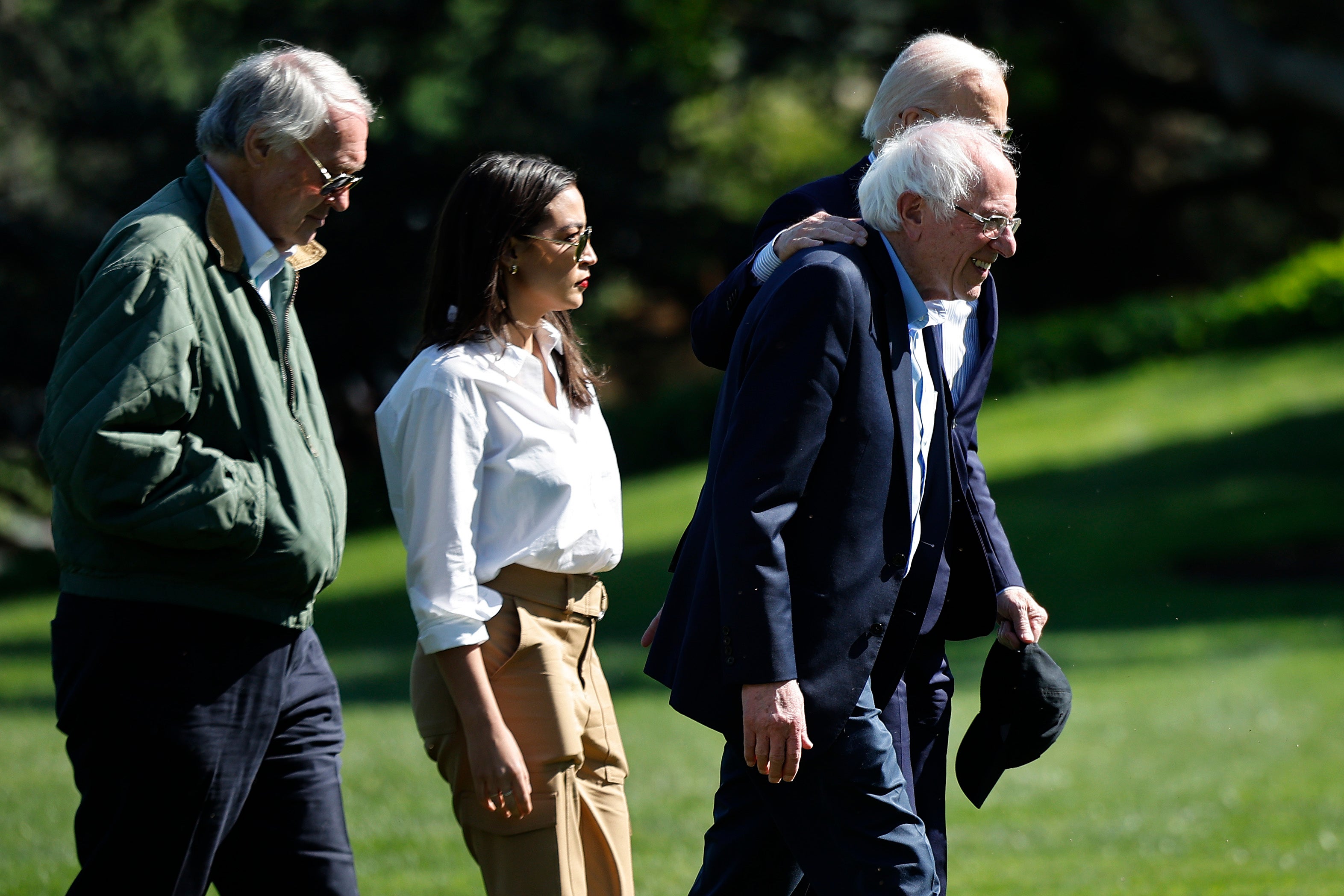 Democratic Representative Alexandria Ocasio-Cortez of New York (center) pictured with President Joe Biden, Sen. Bernie Sanders and Sen. Ed Markey following an Earth Day event in April. She has had to balance criticizing Biden while praising his record