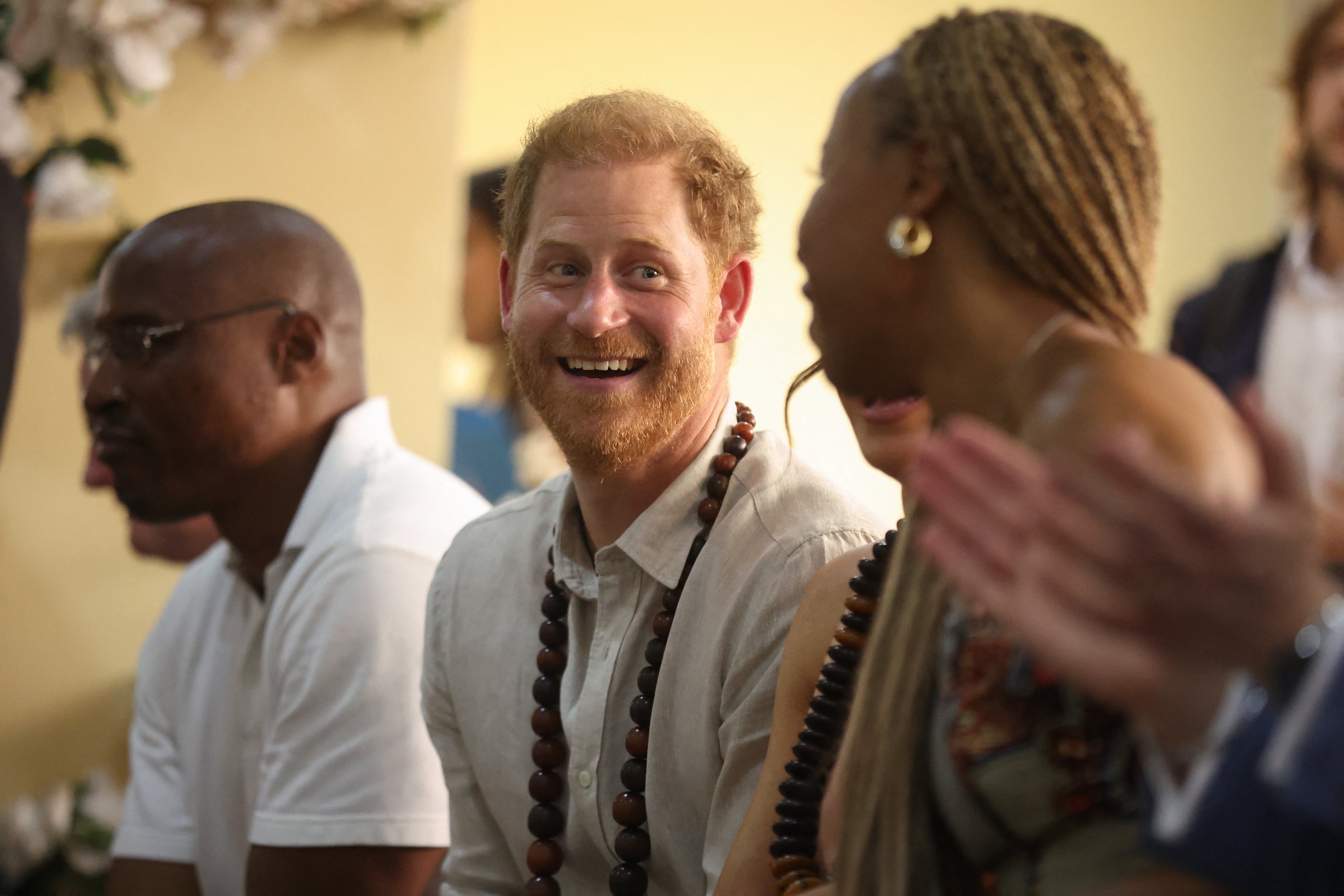 All smiles: Prince Harry finding a warm welcome in Nigeria