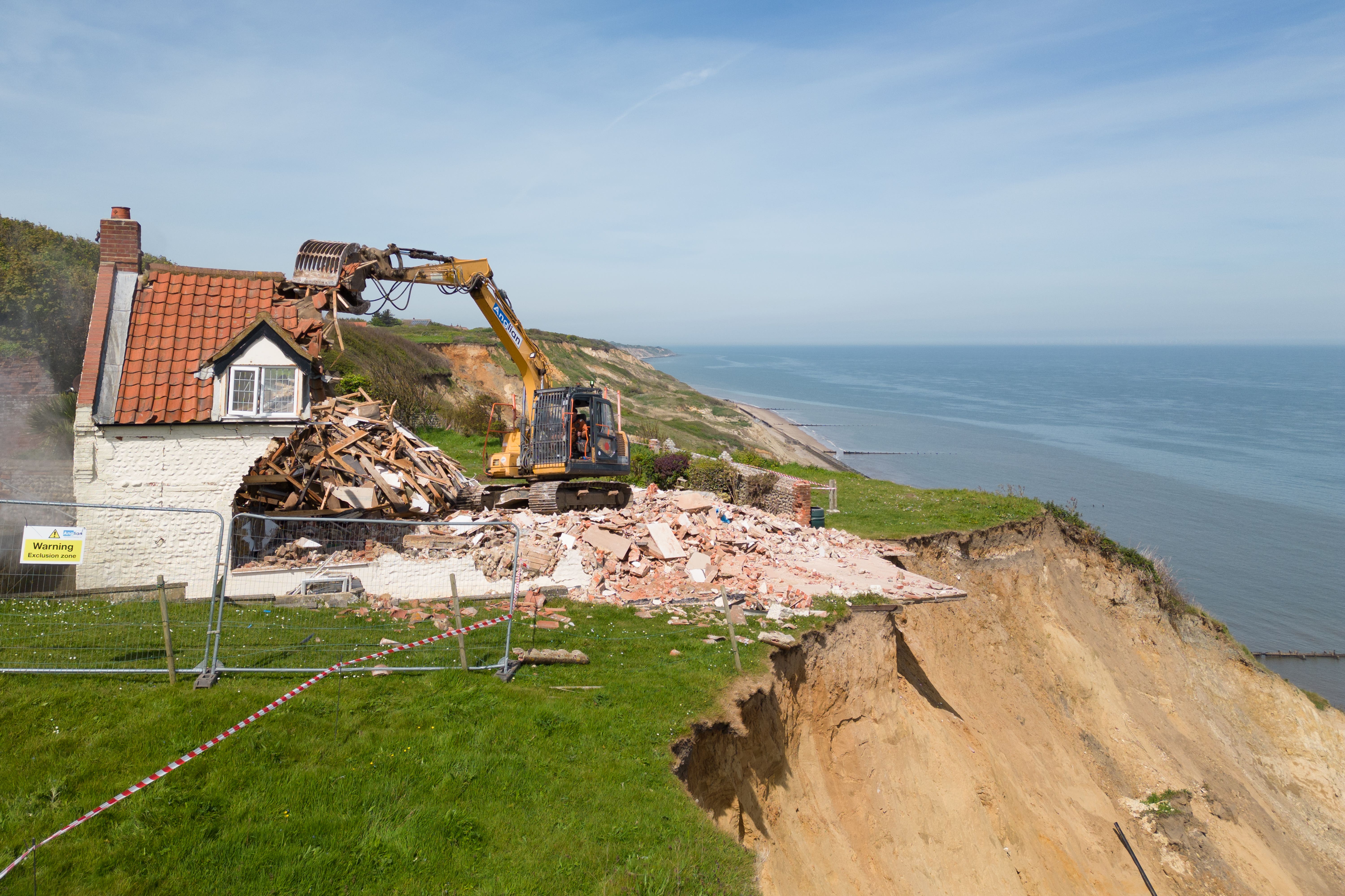 Demolition workers tear down Cliff Farm in Trimingham, Norfolk, which was rendered unsafe to be lived in by the owner after a recent slip left it overhanging the cliff. Picture date: Friday May 10, 2024.