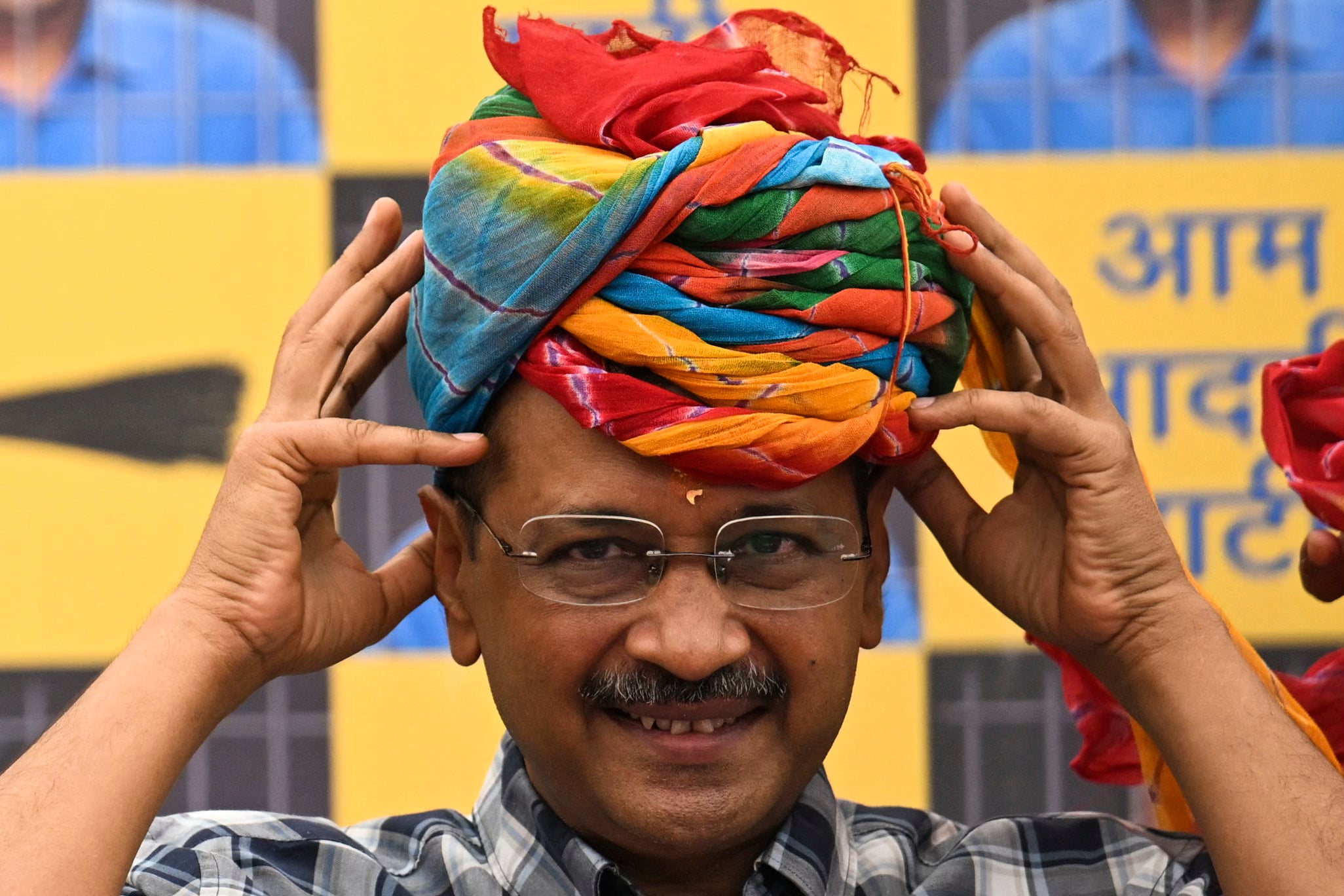 The freed politician puts on a turban during a press conference at party HQ in New Delhi, a day after his release