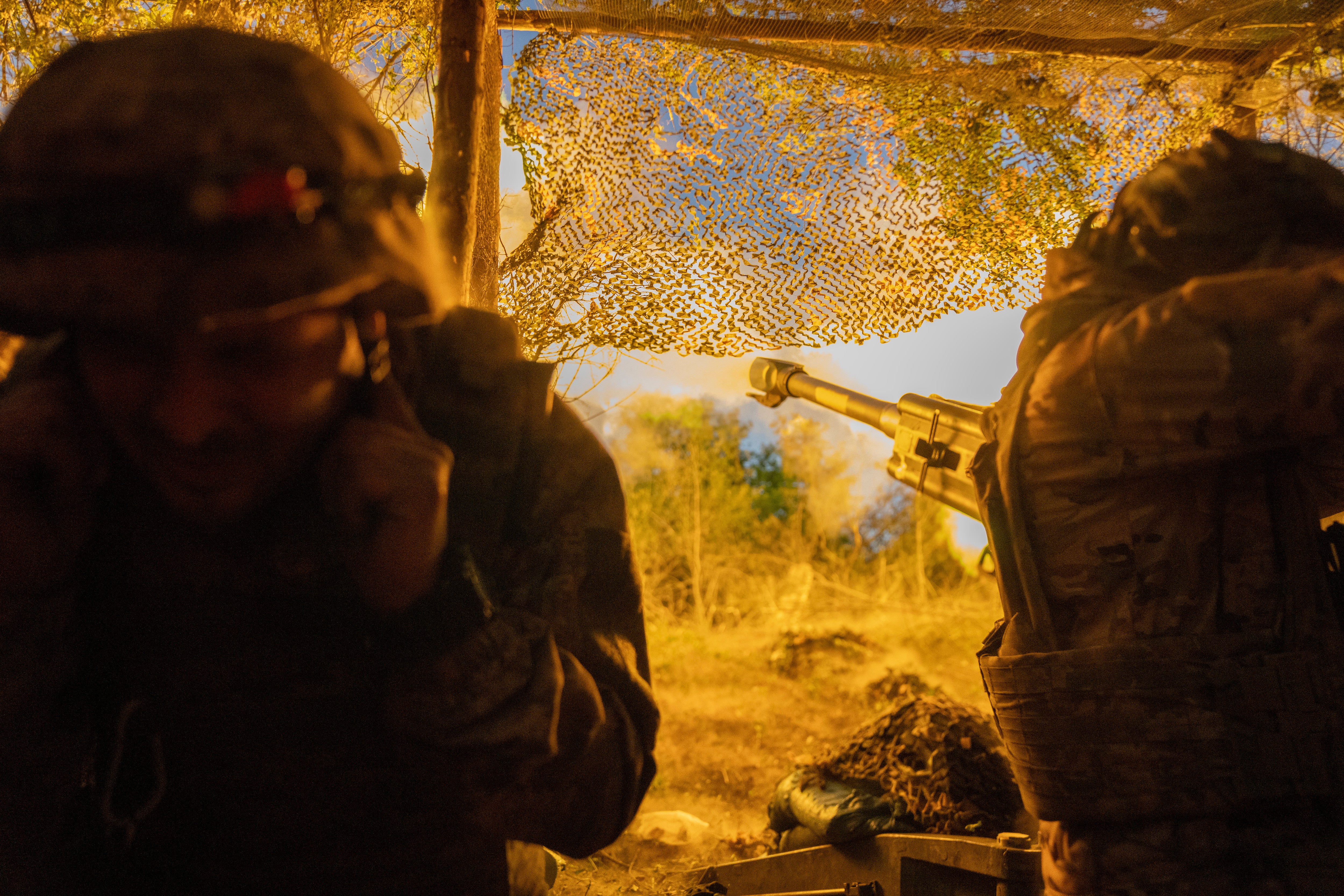 Ukrainian soldiers fire towards Russian positions near the frontline