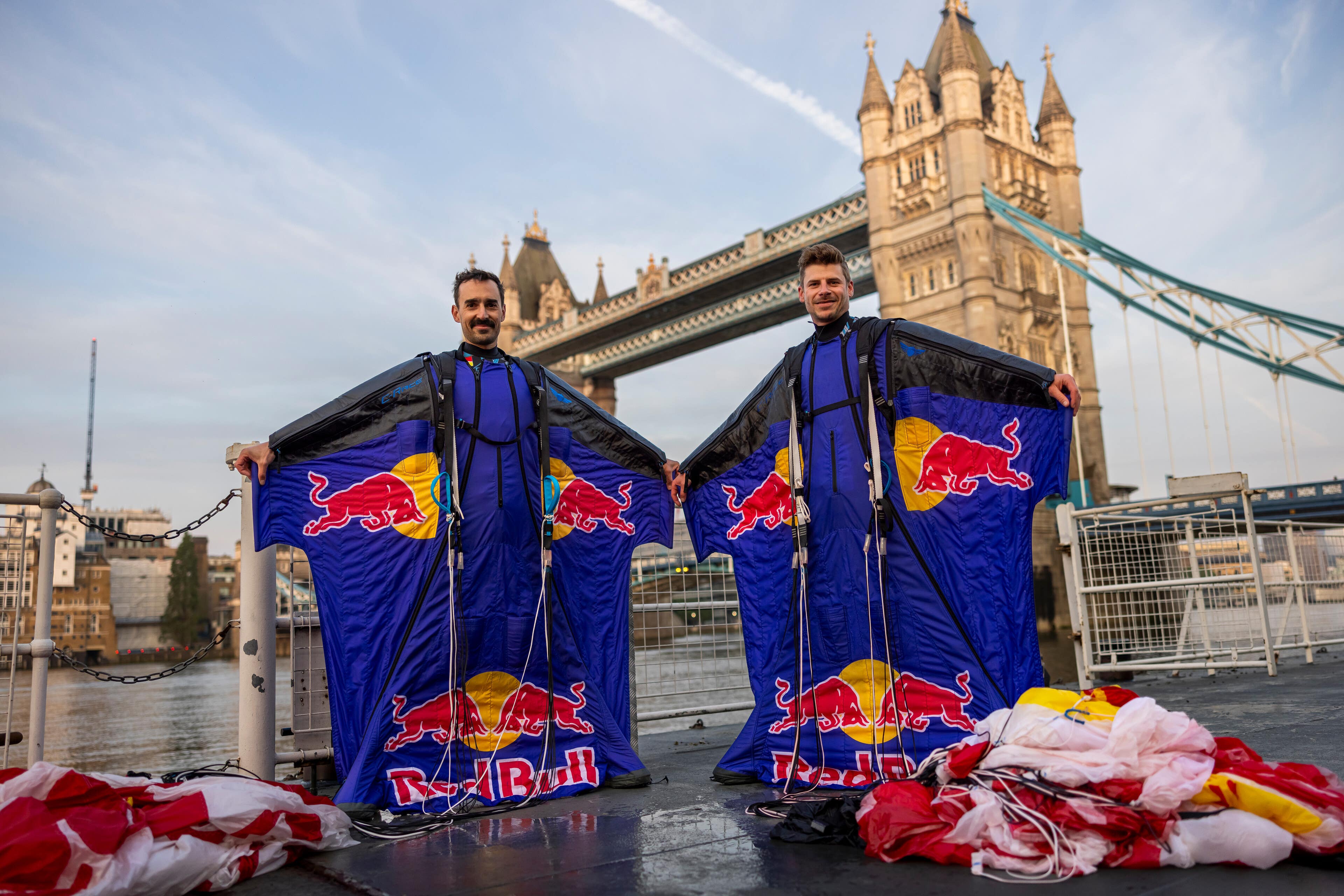 Two professional skydivers successfully completed the world’s first wingsuit flight through London’s Tower Bridge.(Joerg Mitter/Red Bull/PA)