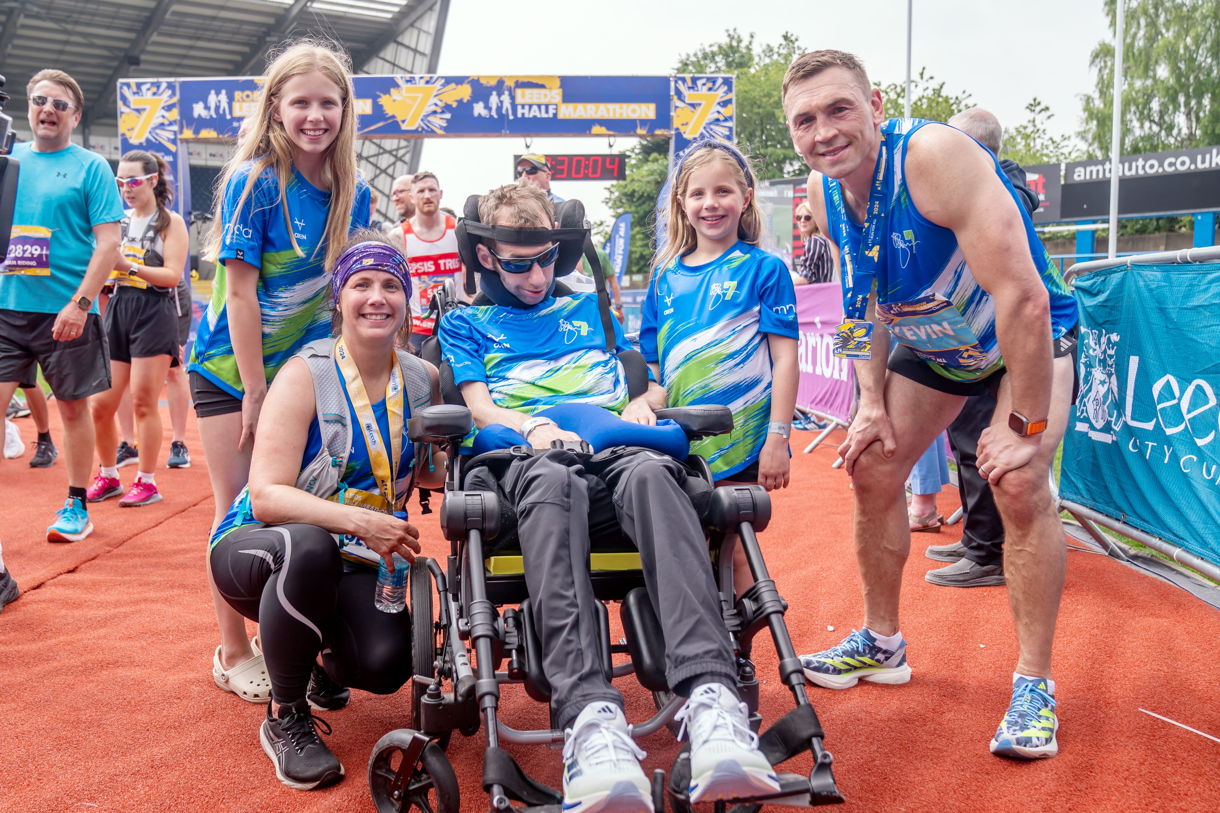 Rob Burrow alongside wife Lindsey, who ran the half marathon, daughters Macy and Maya and Kevin Sinfield (Danny Lawson/PA)