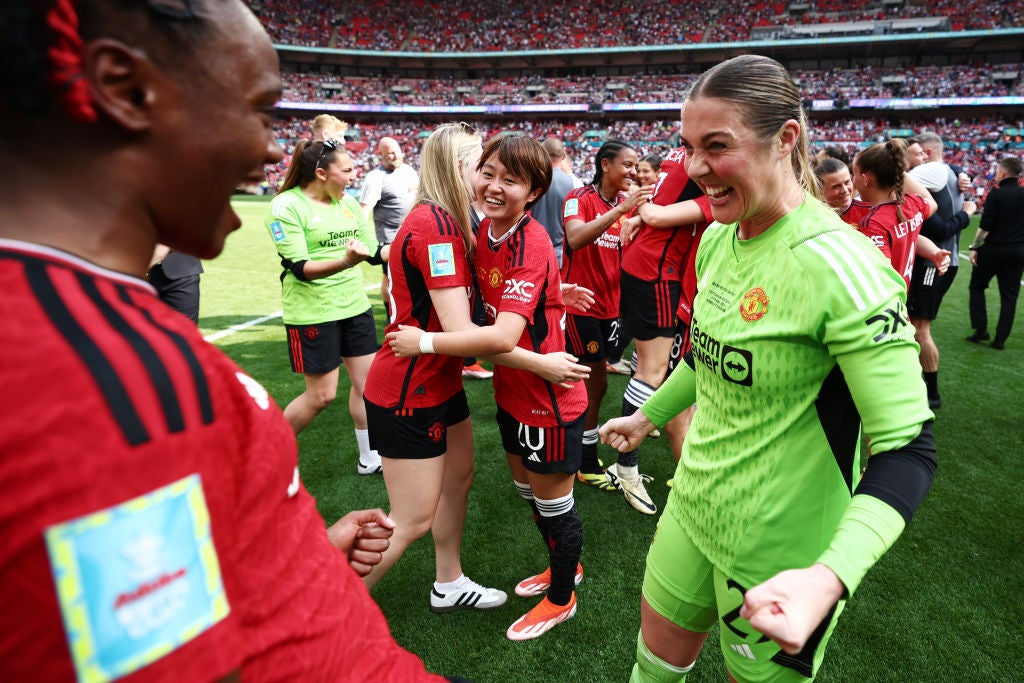 Mary Earps celebrates winning the first honour of her club career