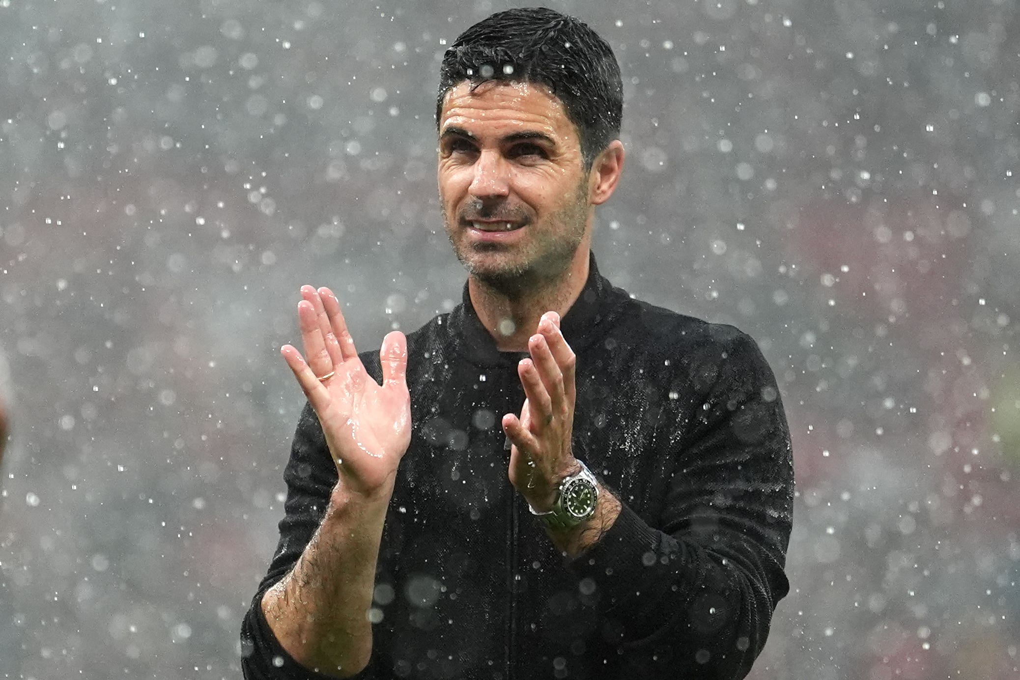 Arsenal manager Mikel Arteta applauds the club’s fans at a soggy Old Trafford (Martin Rickett/PA)