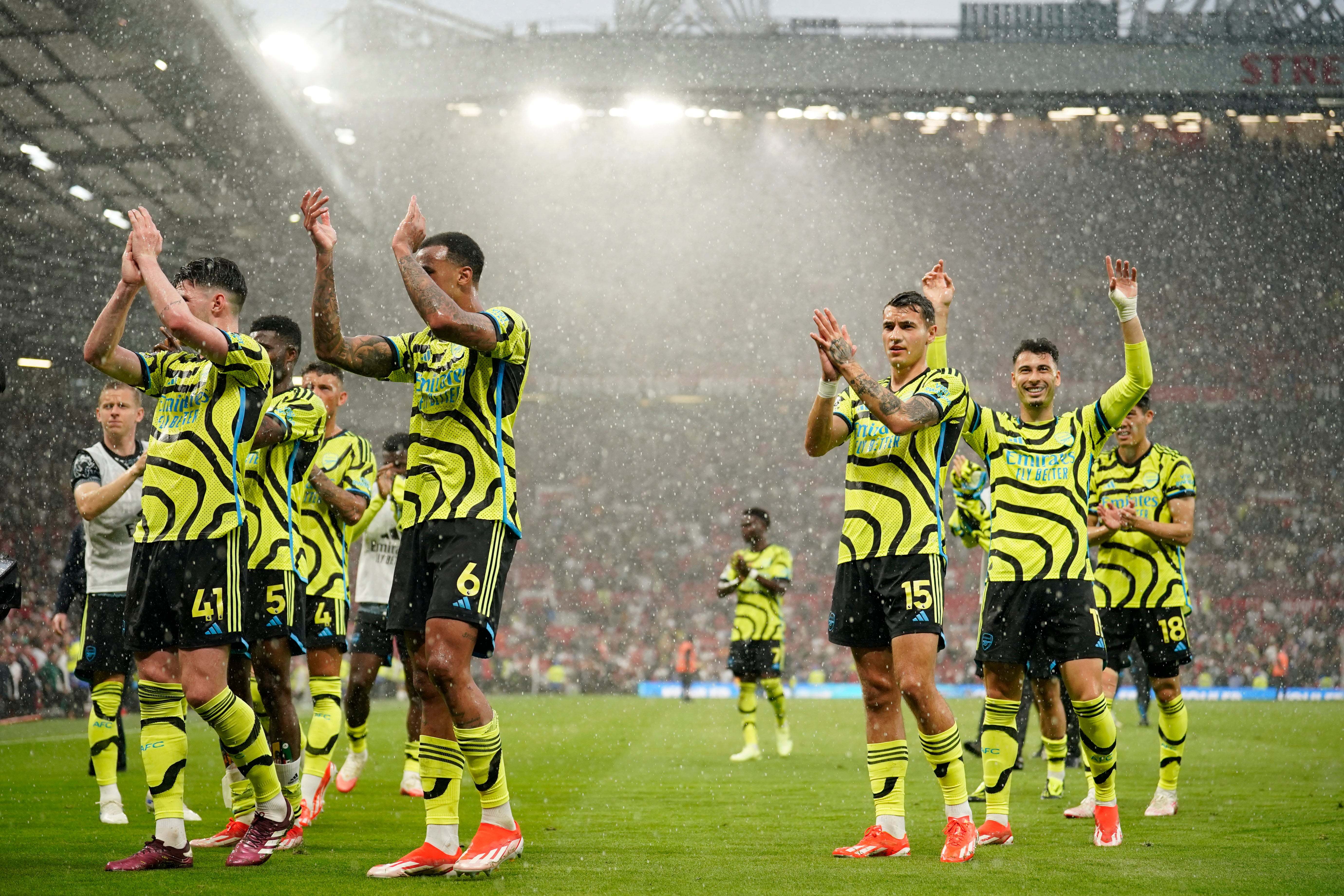 Arsenal's players celebrate after winning at Old Trafford