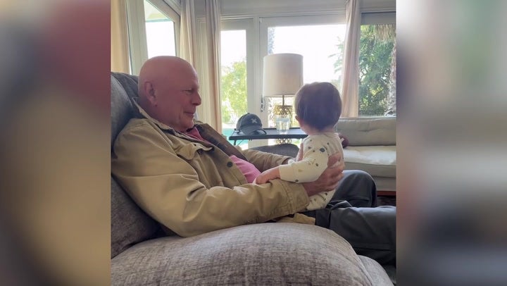 Bruce Willis cuddles his grandchild in a video shared earlier this year