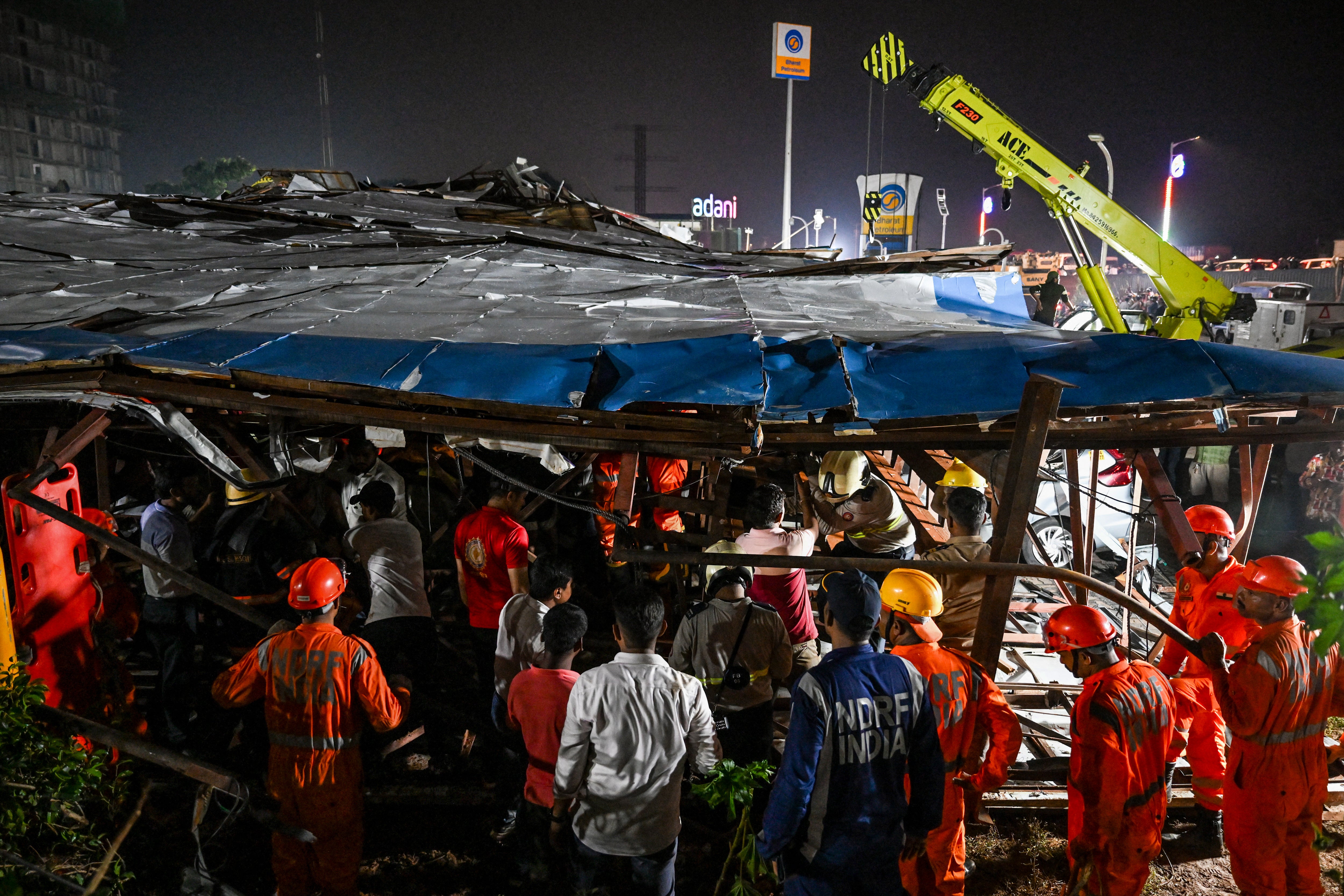 National Disaster Response Force (NDRF) personnel look for survivors during a rescue operation