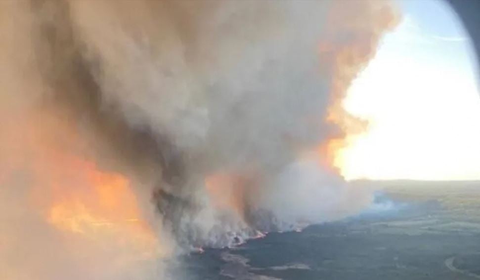 An arial image of the Parker Lake wildfire burning near Fort Nelson in British Columbia. Strong winds fueled the fire Sunday evening into Monday, officials said