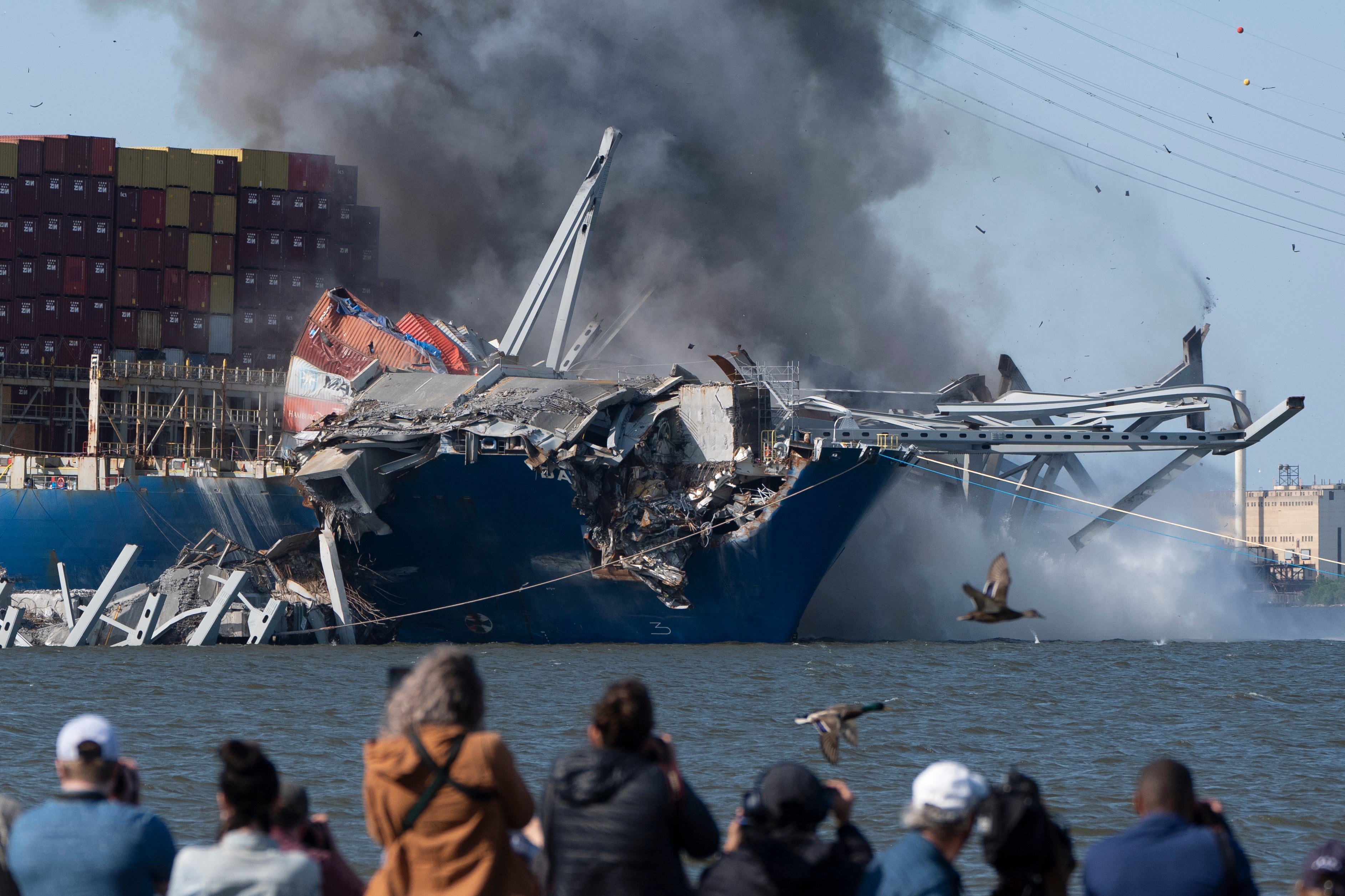 Explosive charges are detonated to bring down sections of the collapsed Francis Scott Key Bridge resting on the container ship Dali on Monday, May 13, 2024, in Baltimore