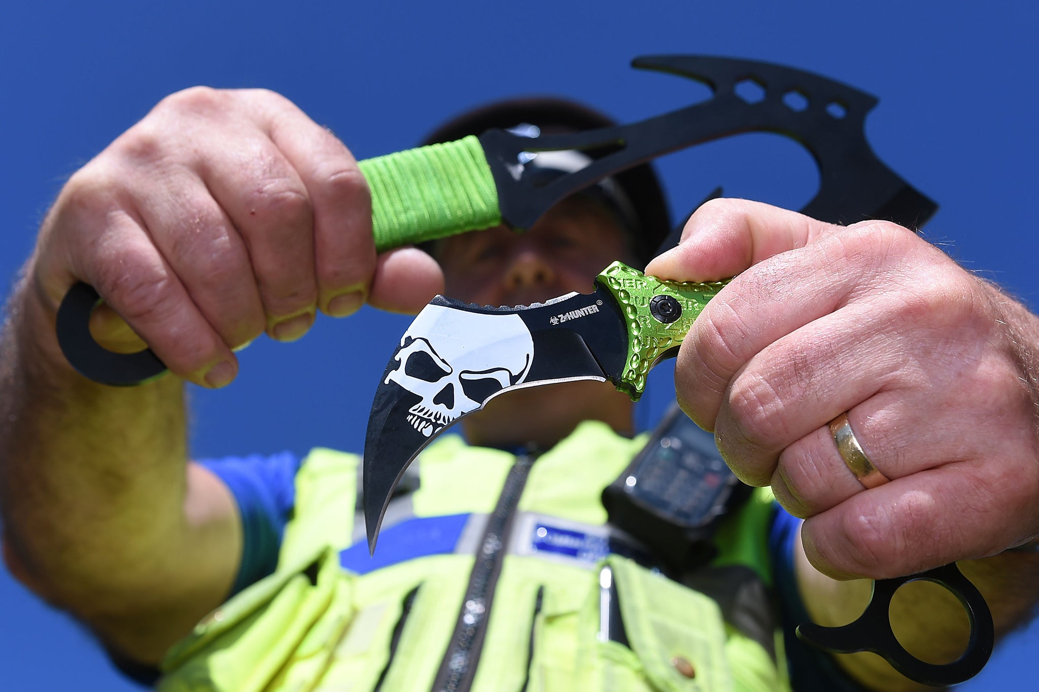 A police officer holds two Zombie knives