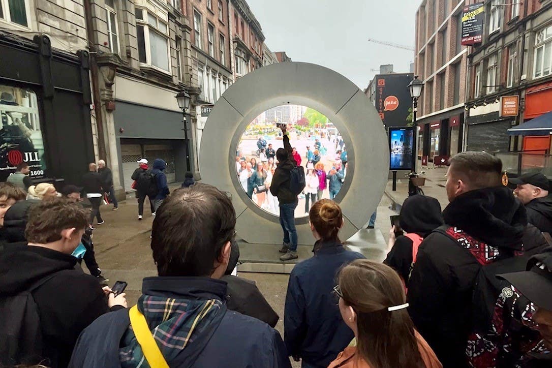 People view the live stream portal between Dublin and New York (Niall Carson/PA)