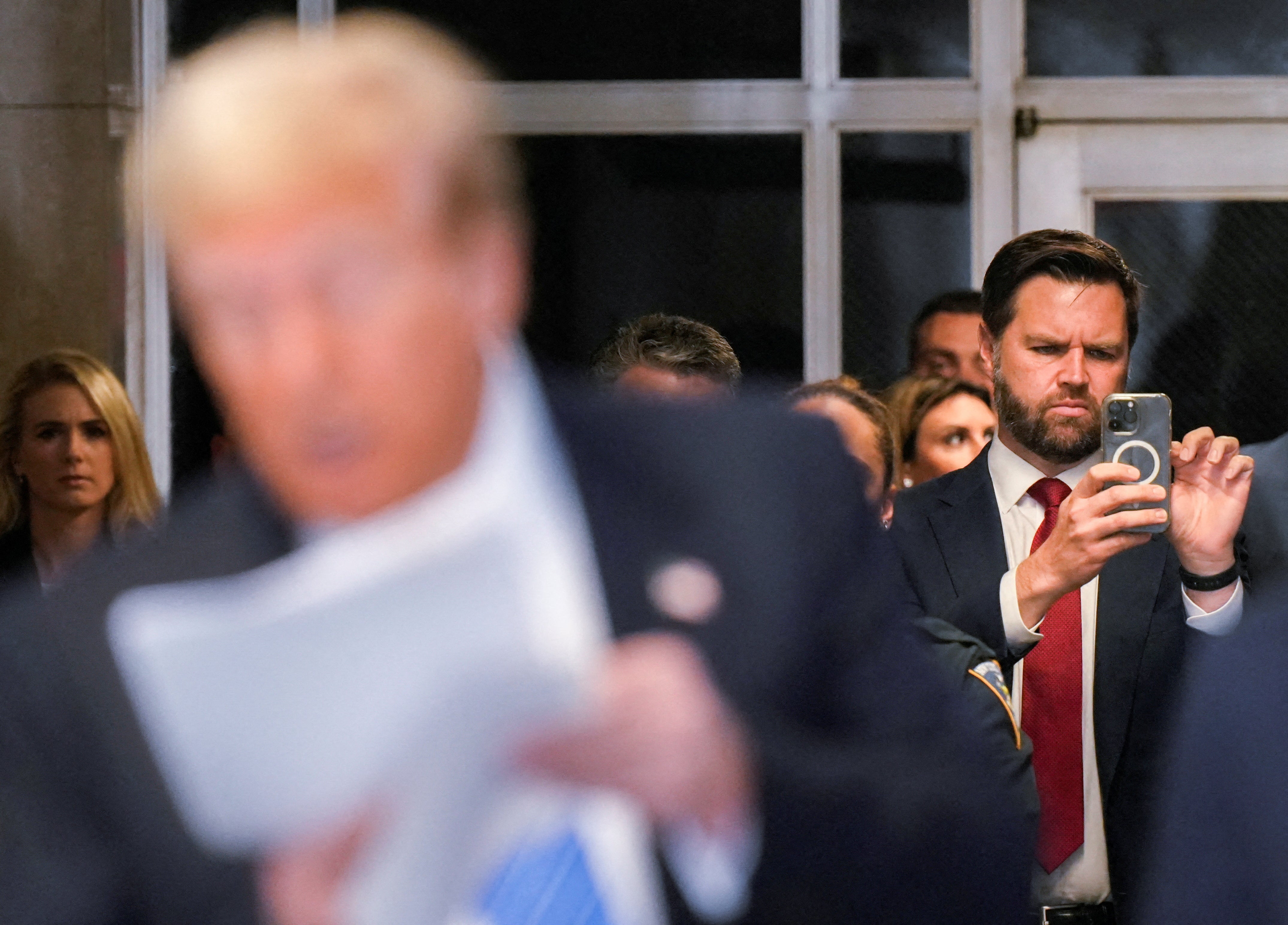 US Senator JD Vance watches Donald Trump address reporters outside his hush money trial on 13 May.