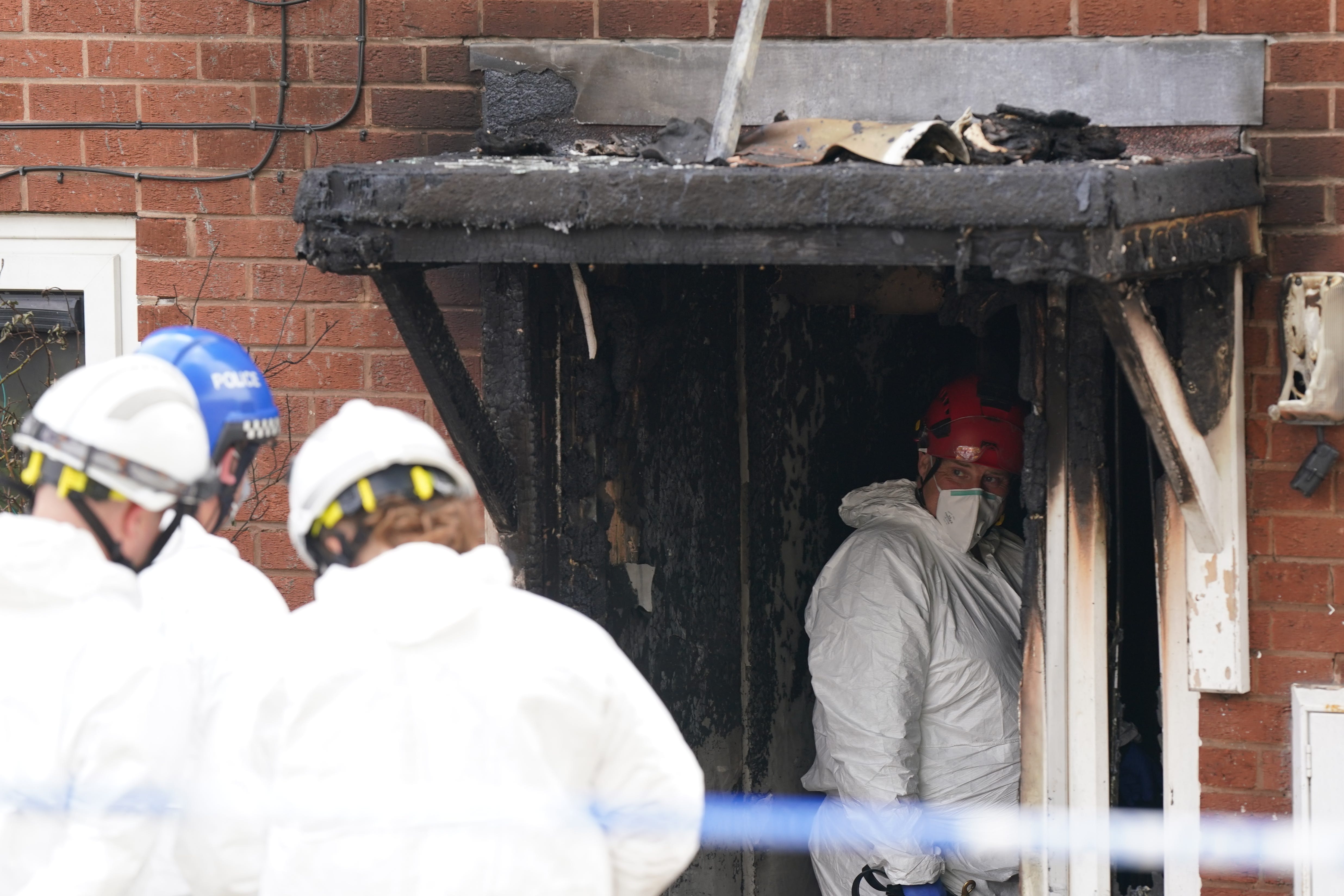 Forensic officers at the scene in Dunstall Hill area of Wolverhampton after two women died and four people were injured in a house fire, two men have been arrested on suspicion of murder. Picture date: Saturday May 11, 2024.