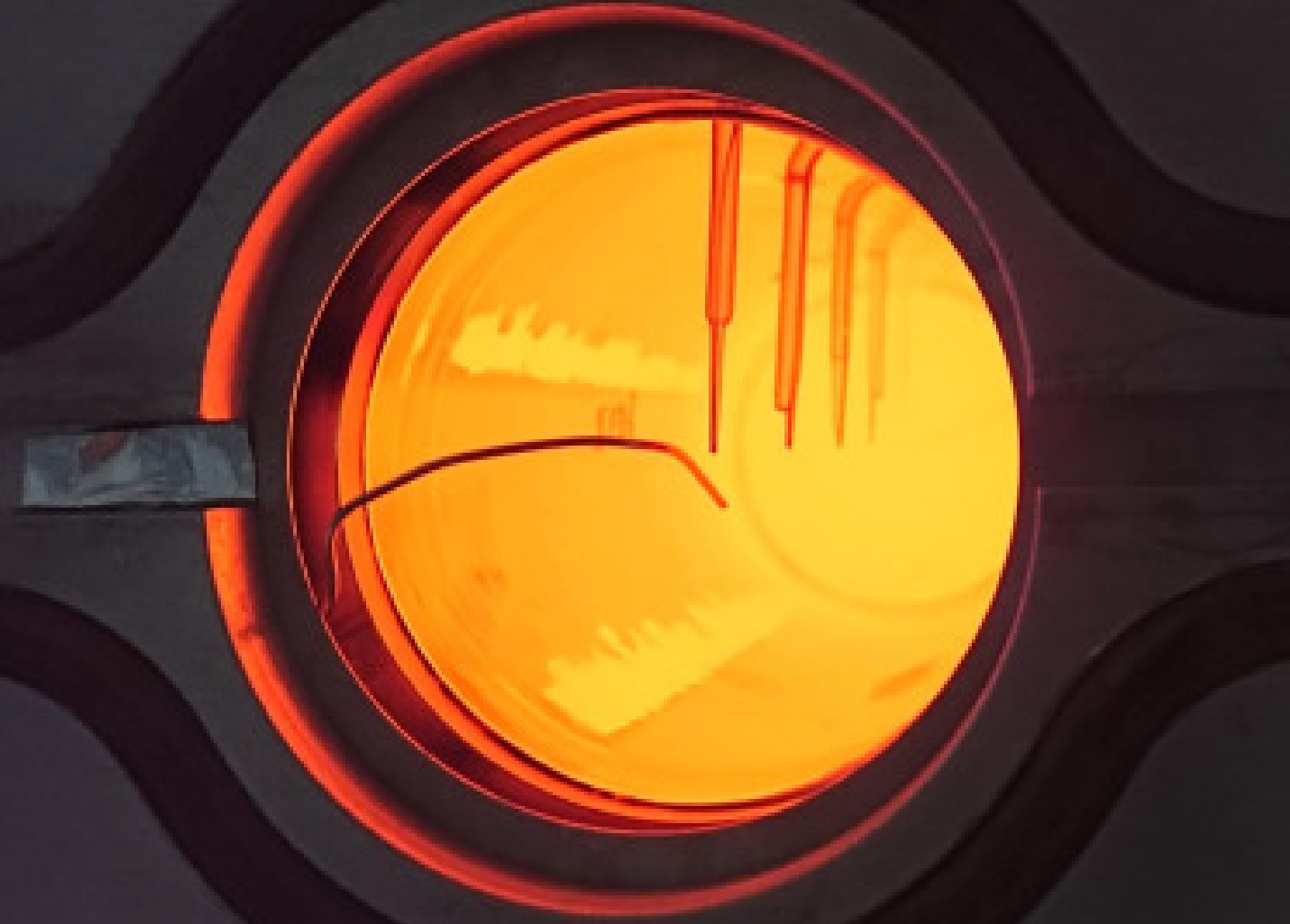 Glowing quartz rod at the end of the experimental device. Absorber is at about 1,050C