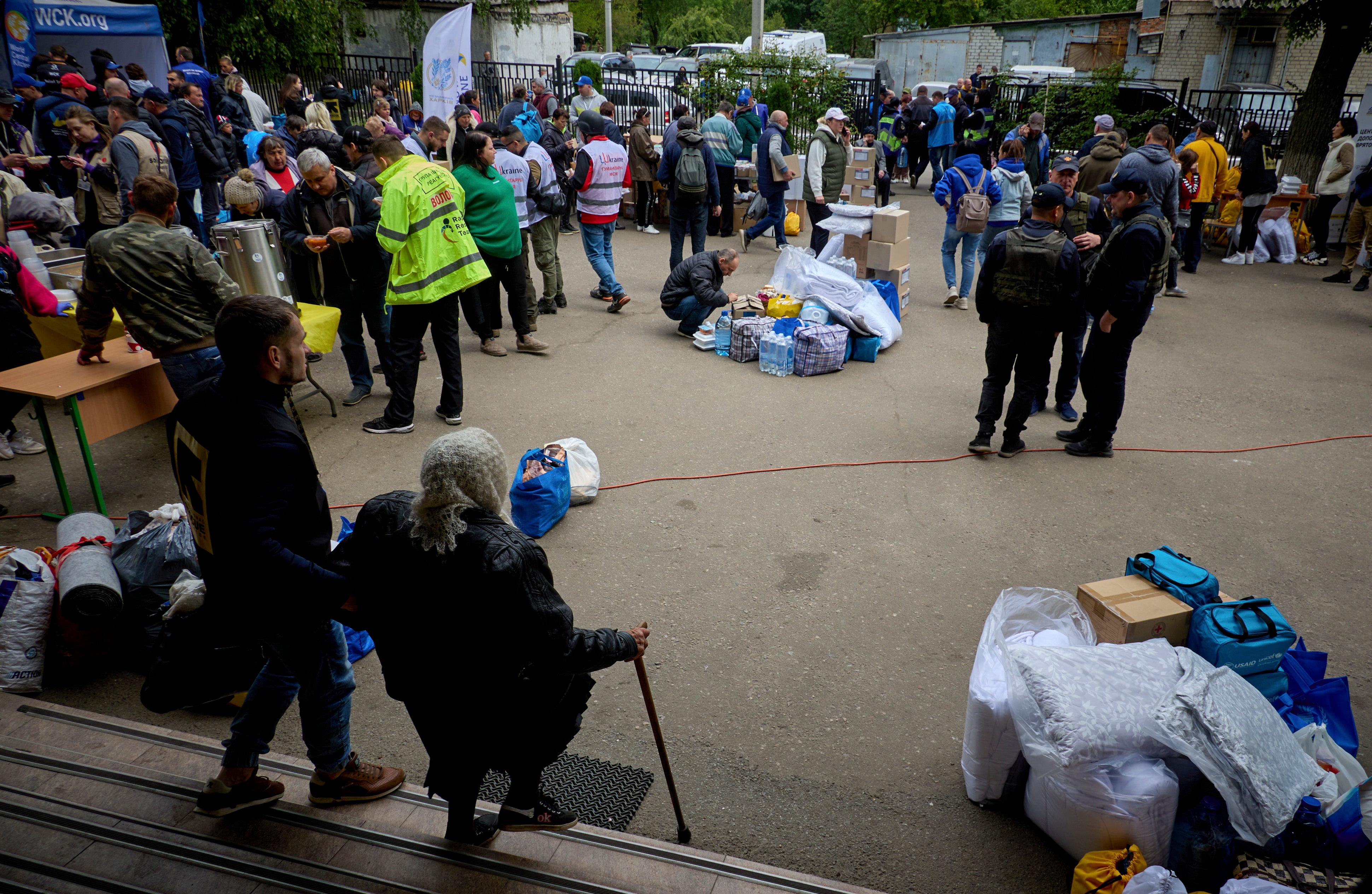 Ukrainian evacuees wait to register at the evacuation center which receives people who had to leave territories close to the Russian border in Kharkiv