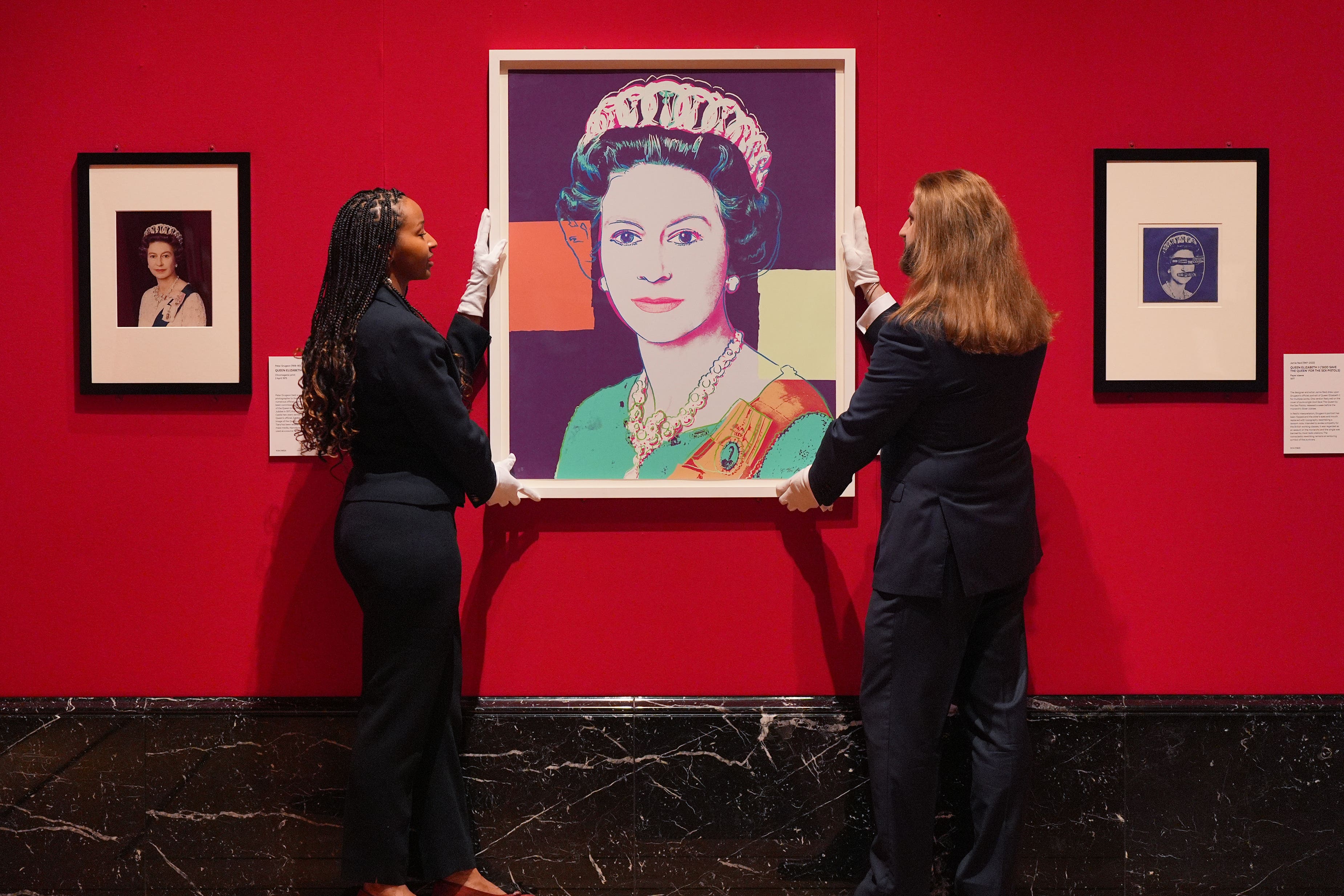 Andy Warhol’s Reigning Queens (Royal Edition): Queen Elizabeth II of the United Kingdom, 1985, during the preview for Royal Portraits exhibition (Yui Mok/PA)