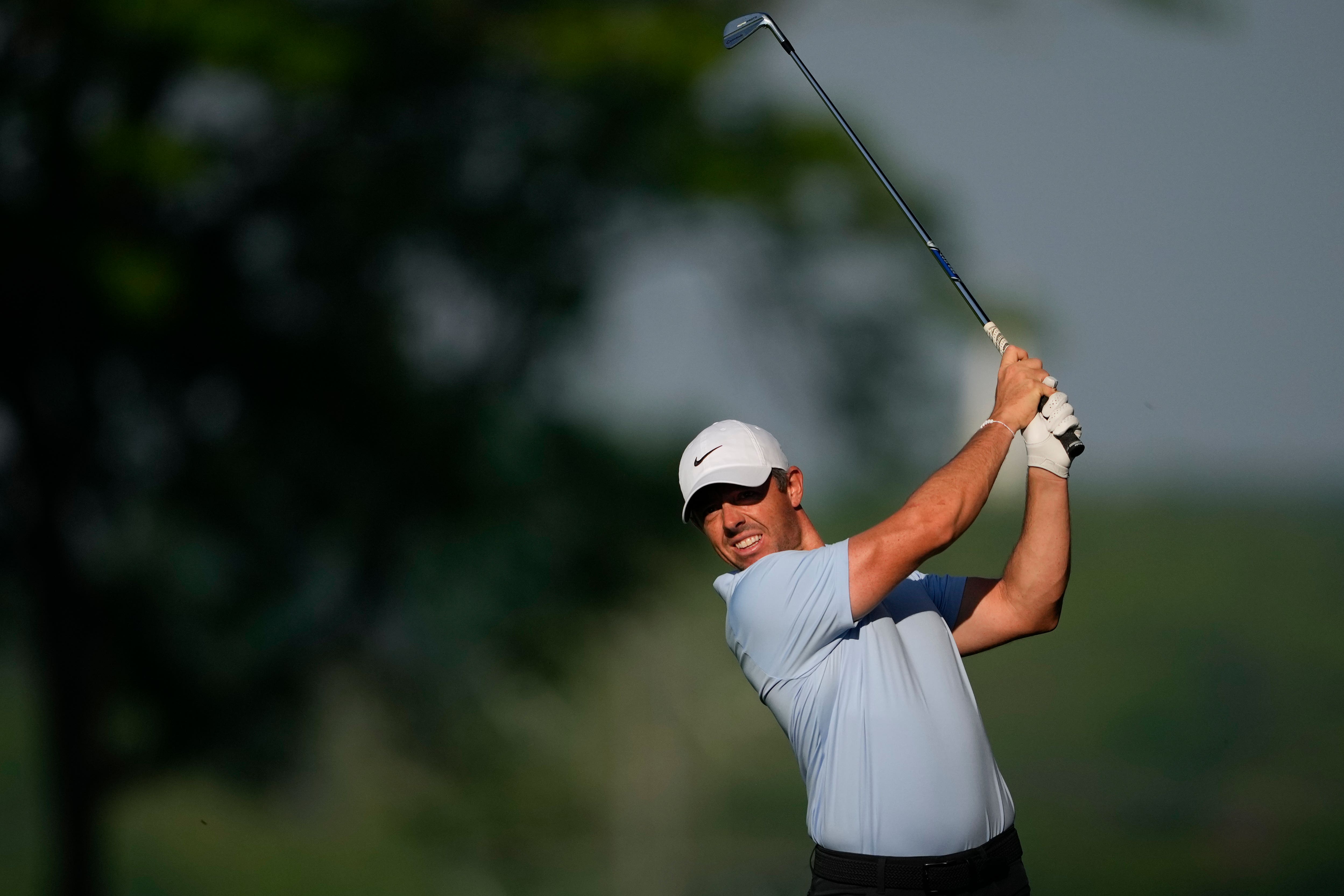 Rory McIlroy hits his second shot on his opening hole, the 10th, in round one of the US PGA Championship (Matt York/AP)