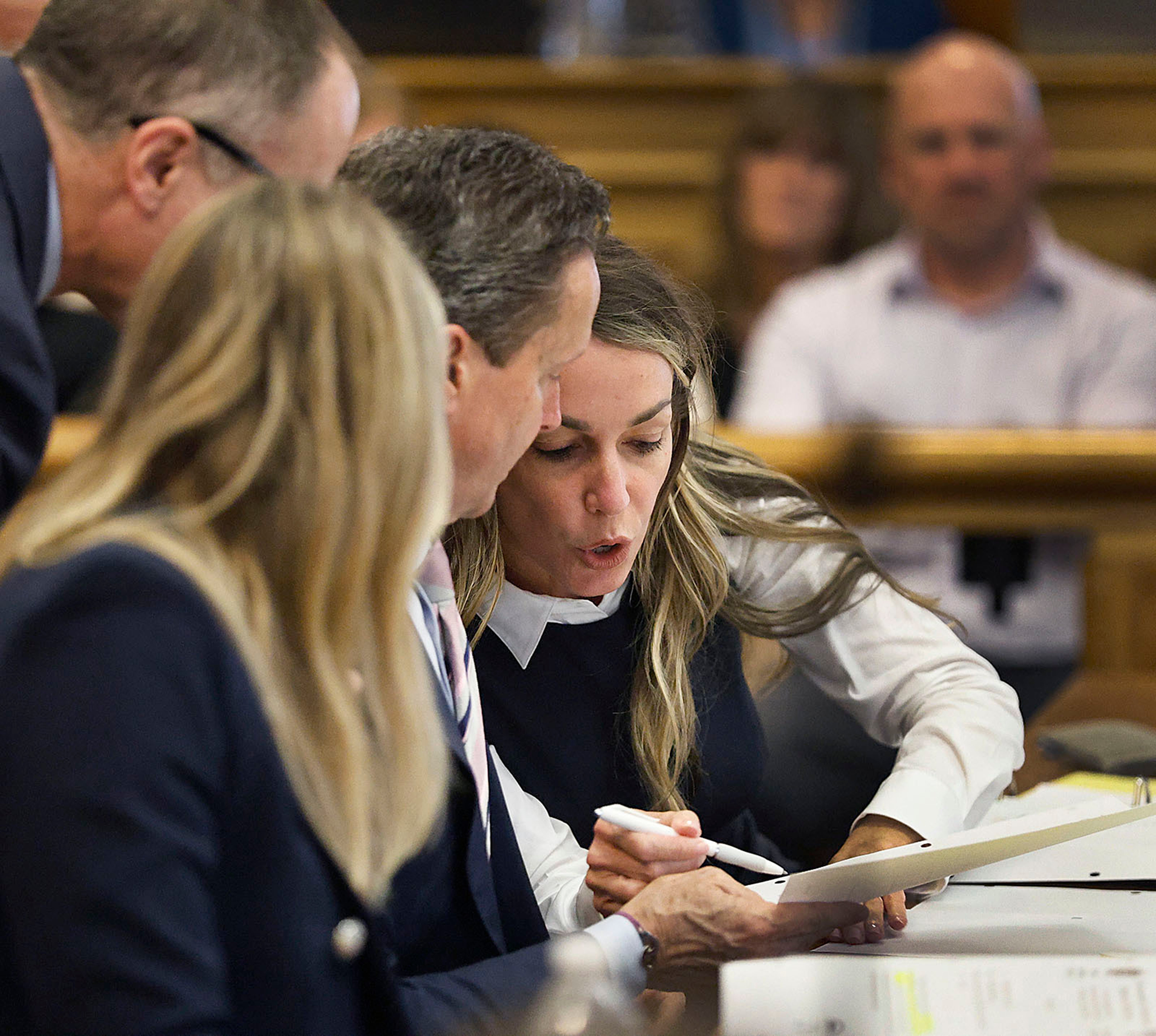 Karen Read talks with her lawyers during her murder trail at Dedham Superior Court on Wednesday