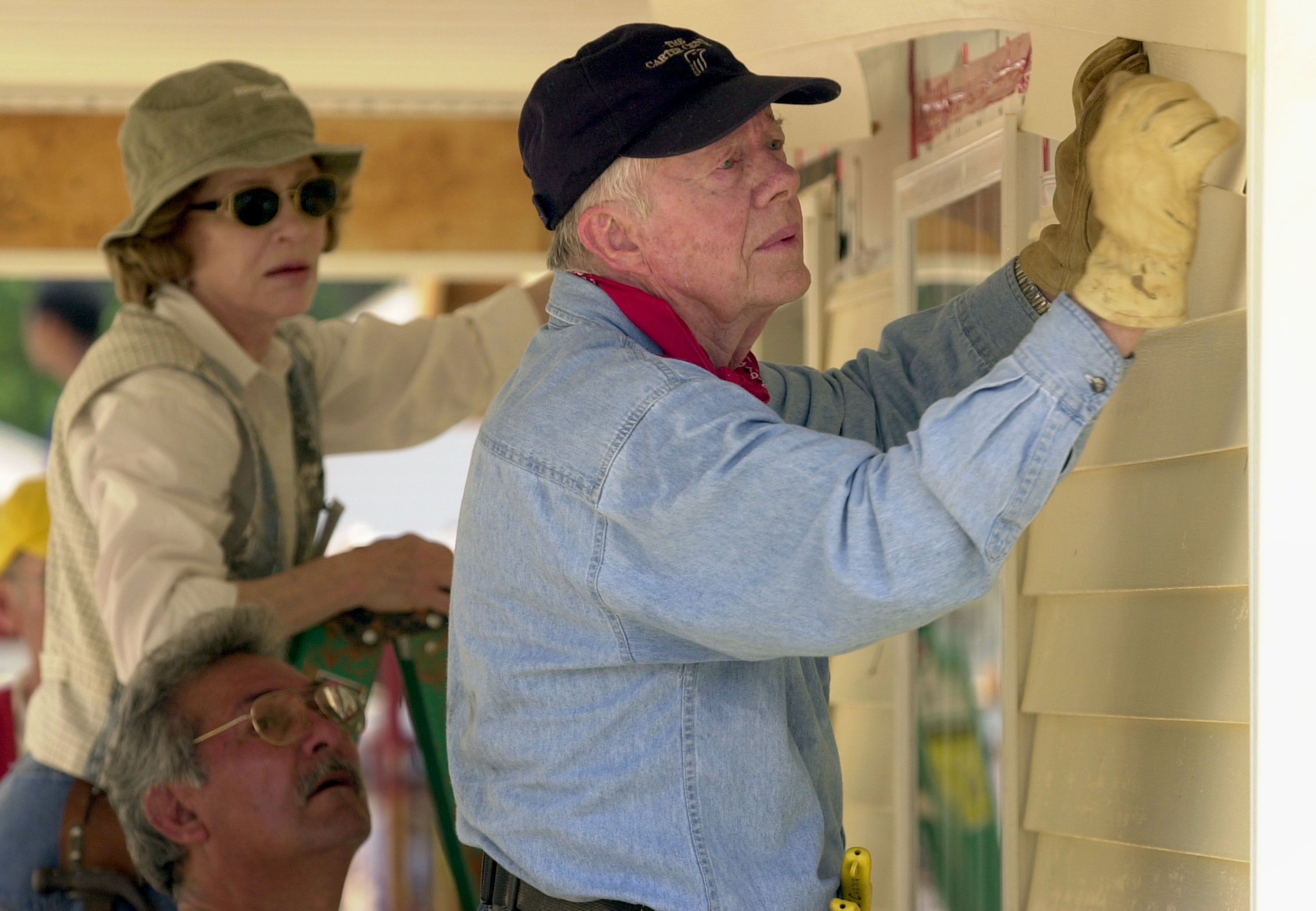 Jimmy Carter (right) and Rosalynn Carter (left) pictured building a home during the 2003 Carter Work Project with Habitat for Humanity. The Carter Foundation’s mission is to raise funds to promote public health and peace