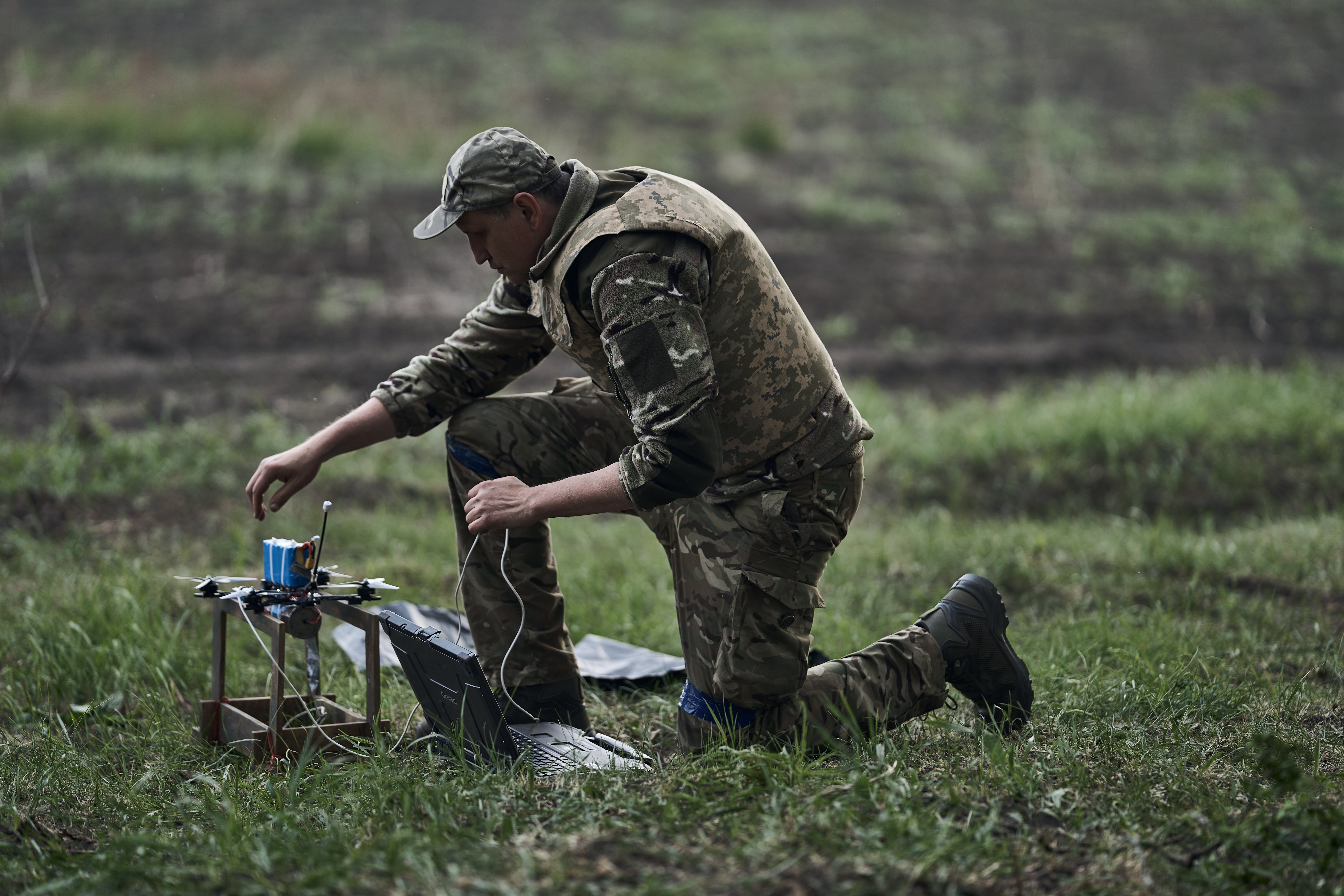 A Ukrainian drone pilot prepares a first-person view (FPV) attack drone for a combat flight in the Kharkiv region, less than five miles from the Russian border