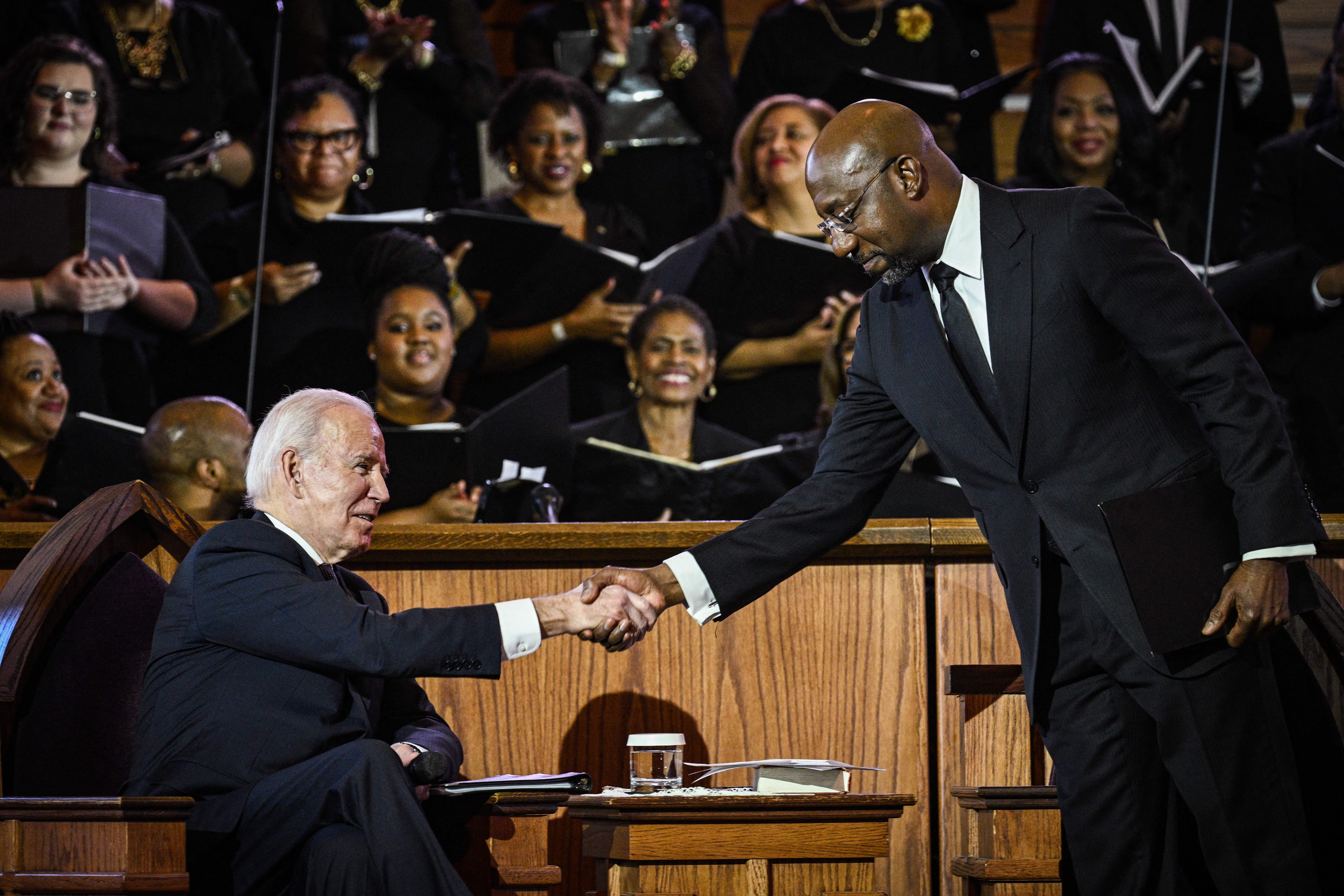 US Senator Raphael Warnock, the pastor at Ebenezer Baptist Church, greets US President Joe Biden during a worship service in Atlanta, Georgia, on 15 January 15 2023