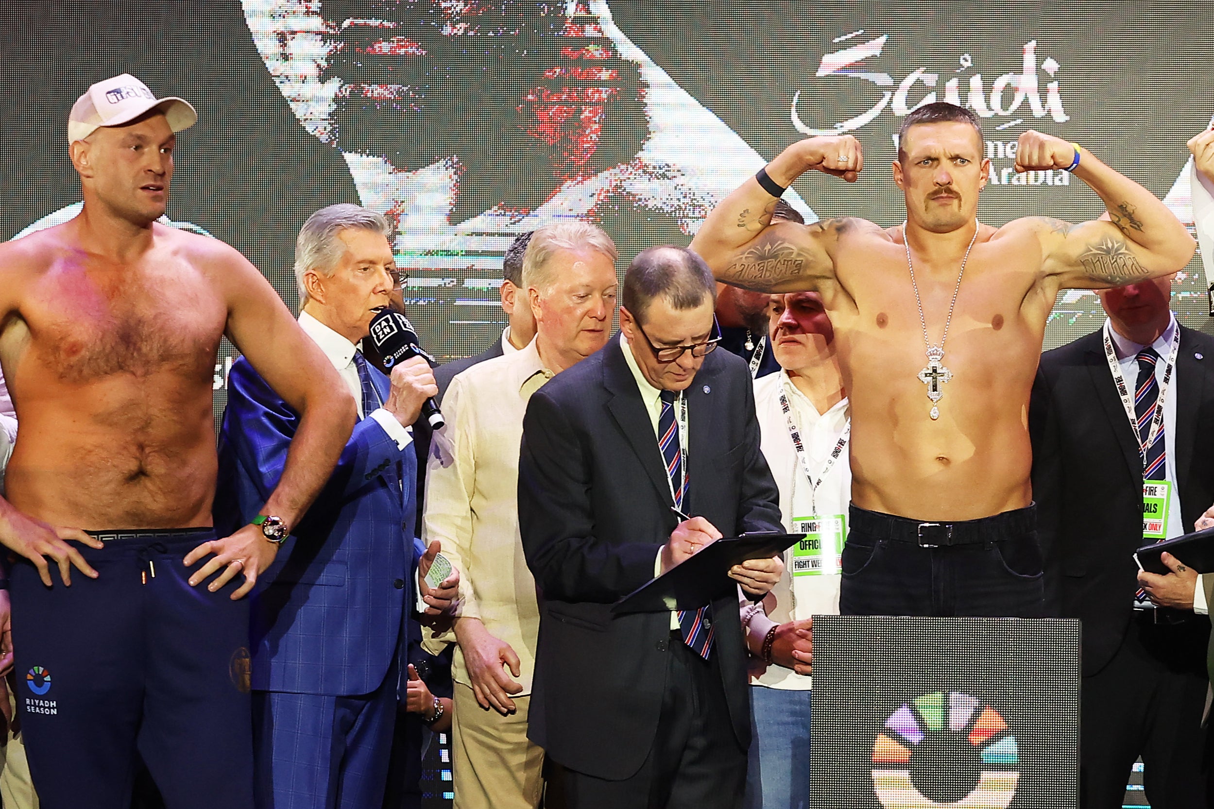 Fury (left) watches on as Usyk weighs in