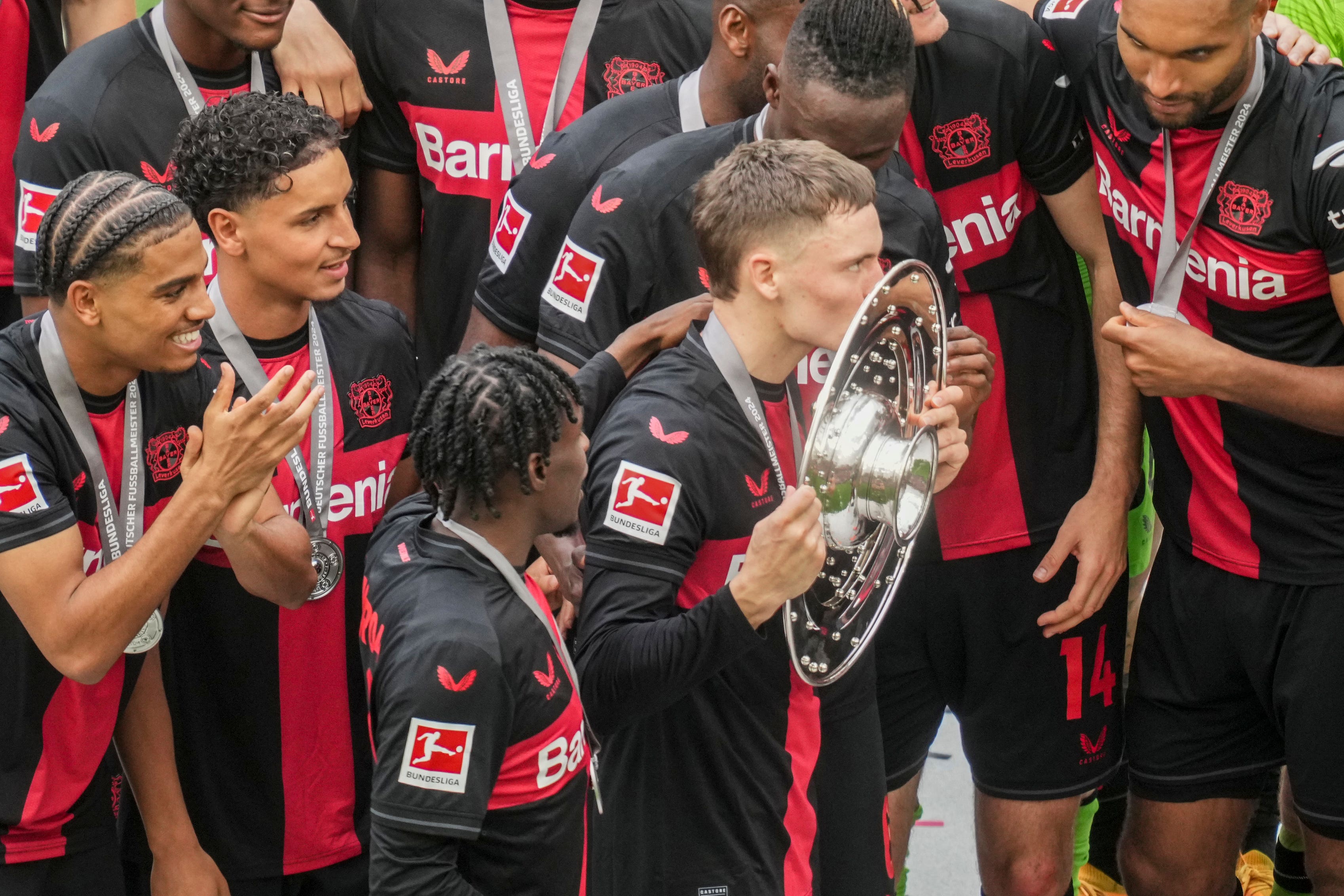 Bayer Leverkusen midfielder Florian Wirtz kisses the Bundesliga trophy after a 2-1 win over Augsburg (Michael Probst/AP/PA)