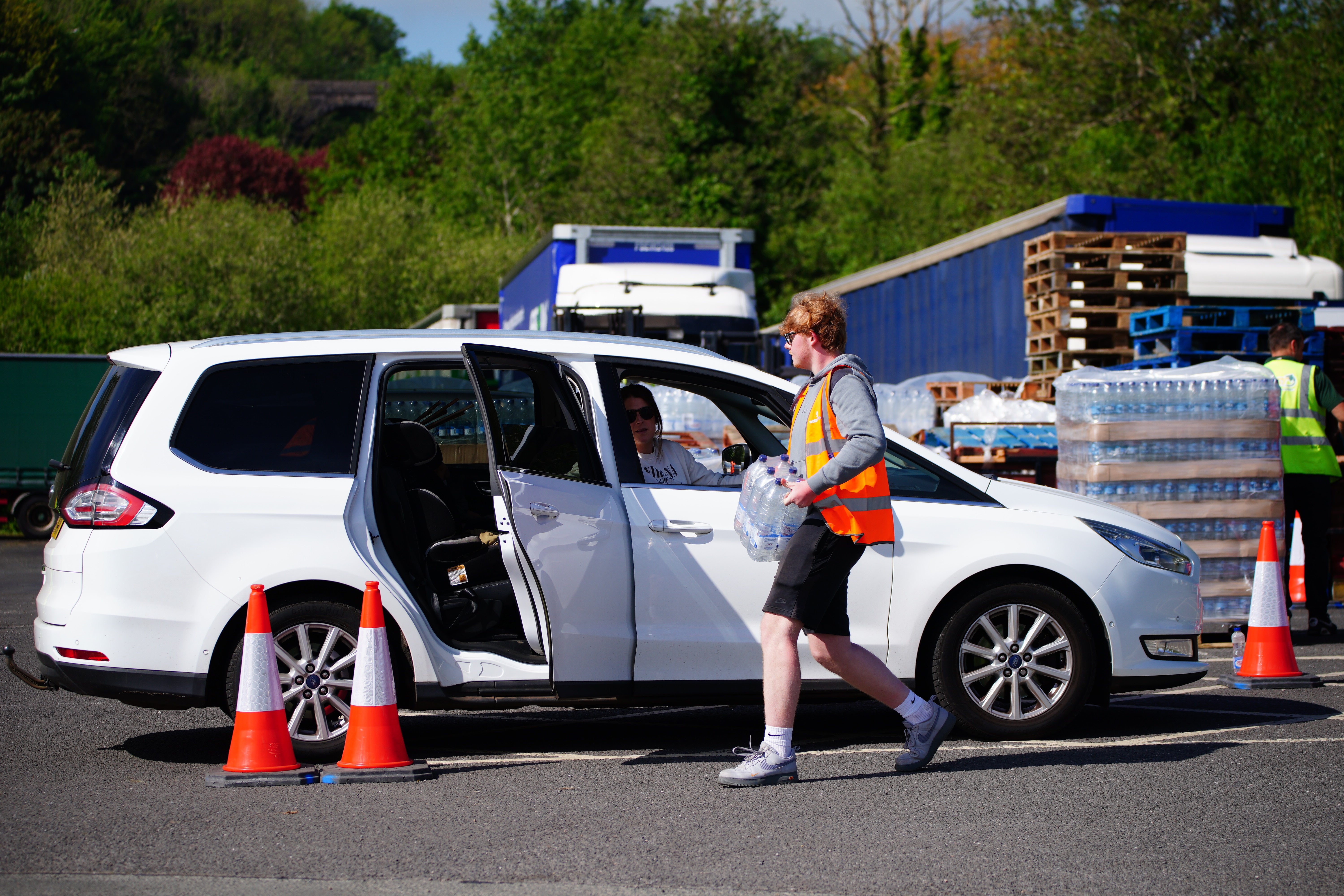 People collecting bottled water at Broadsands Car Park in Paignton