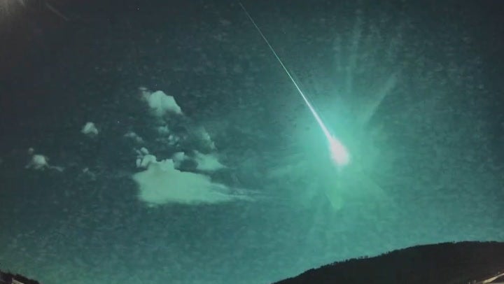 A blue fireball flashes in the night sky as comet fragment soars over Spain